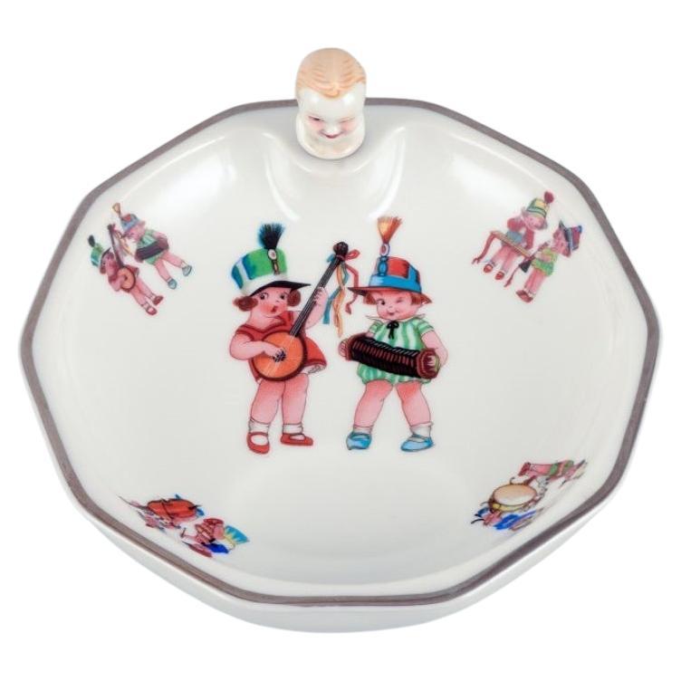 D.F. Limoges, France. Porcelain baby warming bowl. Stopper with a child's face. For Sale