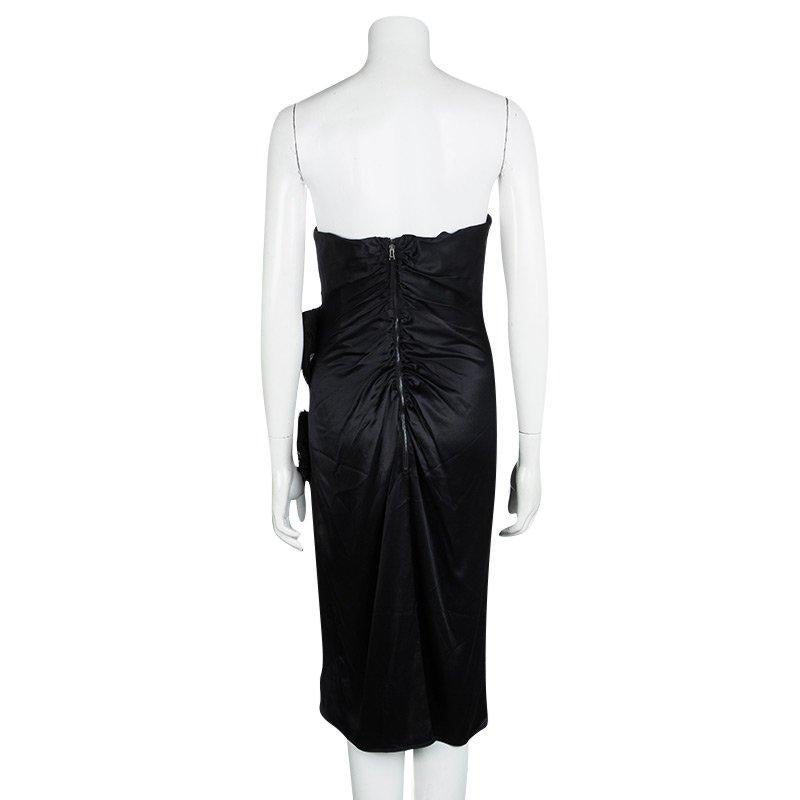 Dress to impress with this stunning strapless dress from D&G. The black dress has a strapless style with a scalloped hem and lace trims. The dress also features a back zipper and fringe details on the sides. Complete this look with dangling earrings