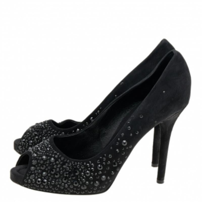 There are some shoes that stand the test of time and fashion cycles, these timeless D&G pumps are the one. Crafted from suede in a black shade, they are designed with sleek cuts, peep-toes, crystal embellishments, and tall heels.