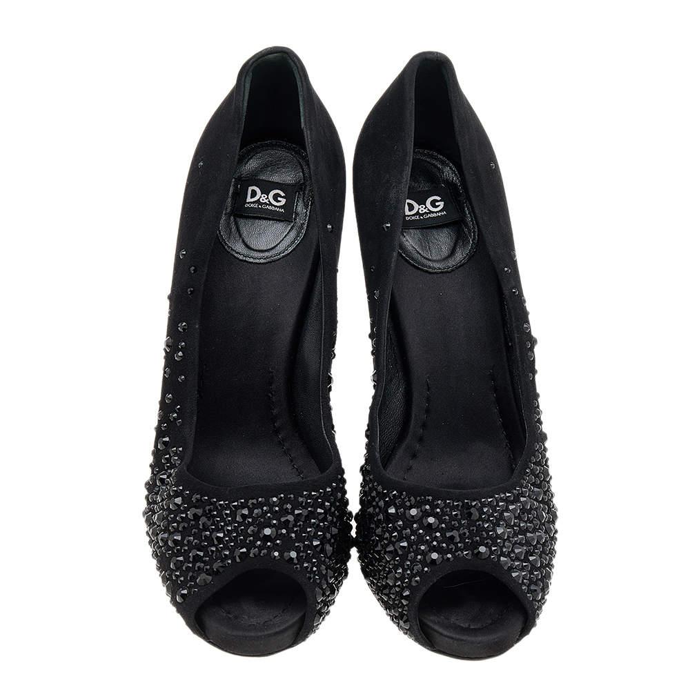 There are some shoes that stand the test of time and fashion cycles, these timeless D&G pumps are the one. Crafted from suede in a black shade, they are designed with sleek cuts, peep-toes, crystal embellishments, and tall heels.

