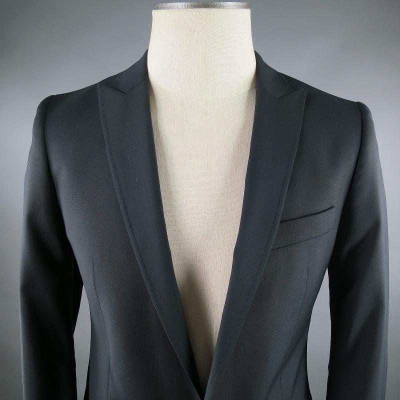 This D&G By Dolce & Gabbana Sport Coat features a Single-Button Front, Peak Lapel Collar with tone stitching around edges. Detailed with 2 front Flap Pockets and Single back vent. New with Tags.Tag Size: IT 46 R 

Measurements: 
  Shoulders: 16 1/2