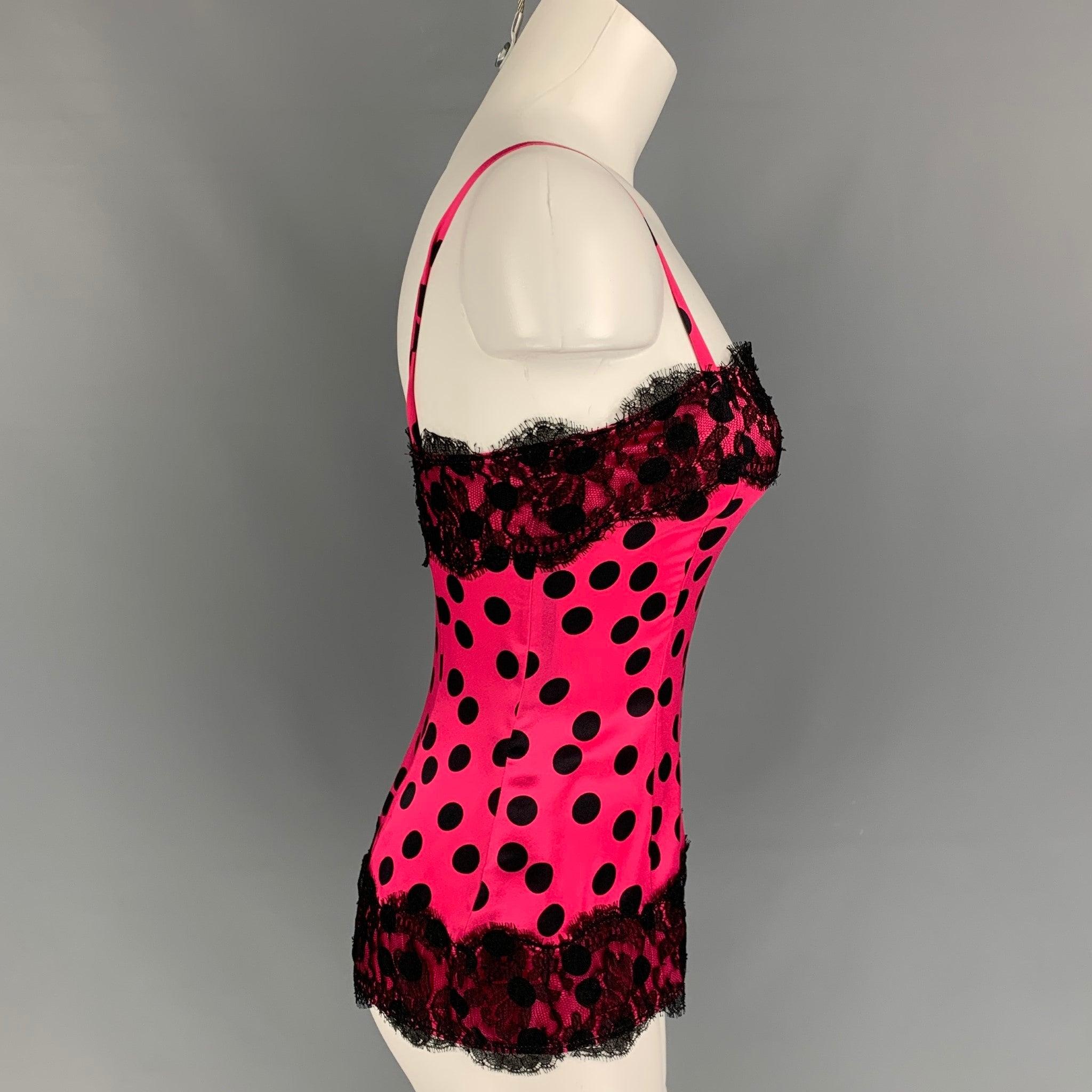 D&G by DOLCE & GABBANA casual top comes in a pink & black polka dot silk featuring a lace trim design, spaghetti straps, and a back zip up closure.
Excellent
Pre-Owned Condition. 

Marked:   38 

Measurements: 
  Bust: 29 inches  Length: 14 inches