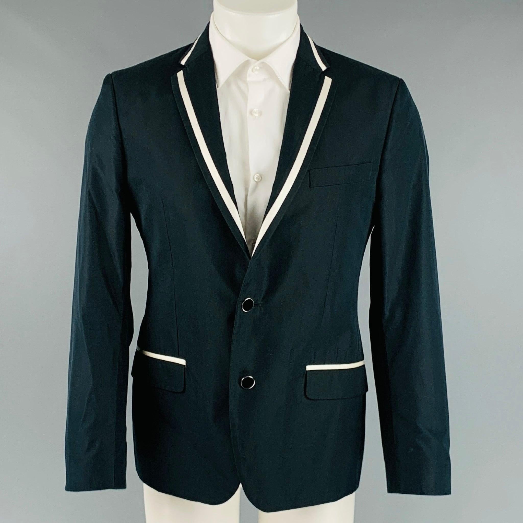 D&G by DOLCE & GABBANA sport coat comes in a black and white cotton blend woven with a full liner featuring a notch lapel, flap pockets, and a double button closure. Made in Italy.Excellent Pre-Owned Condition. 

Marked:   50 

Measurements: 
