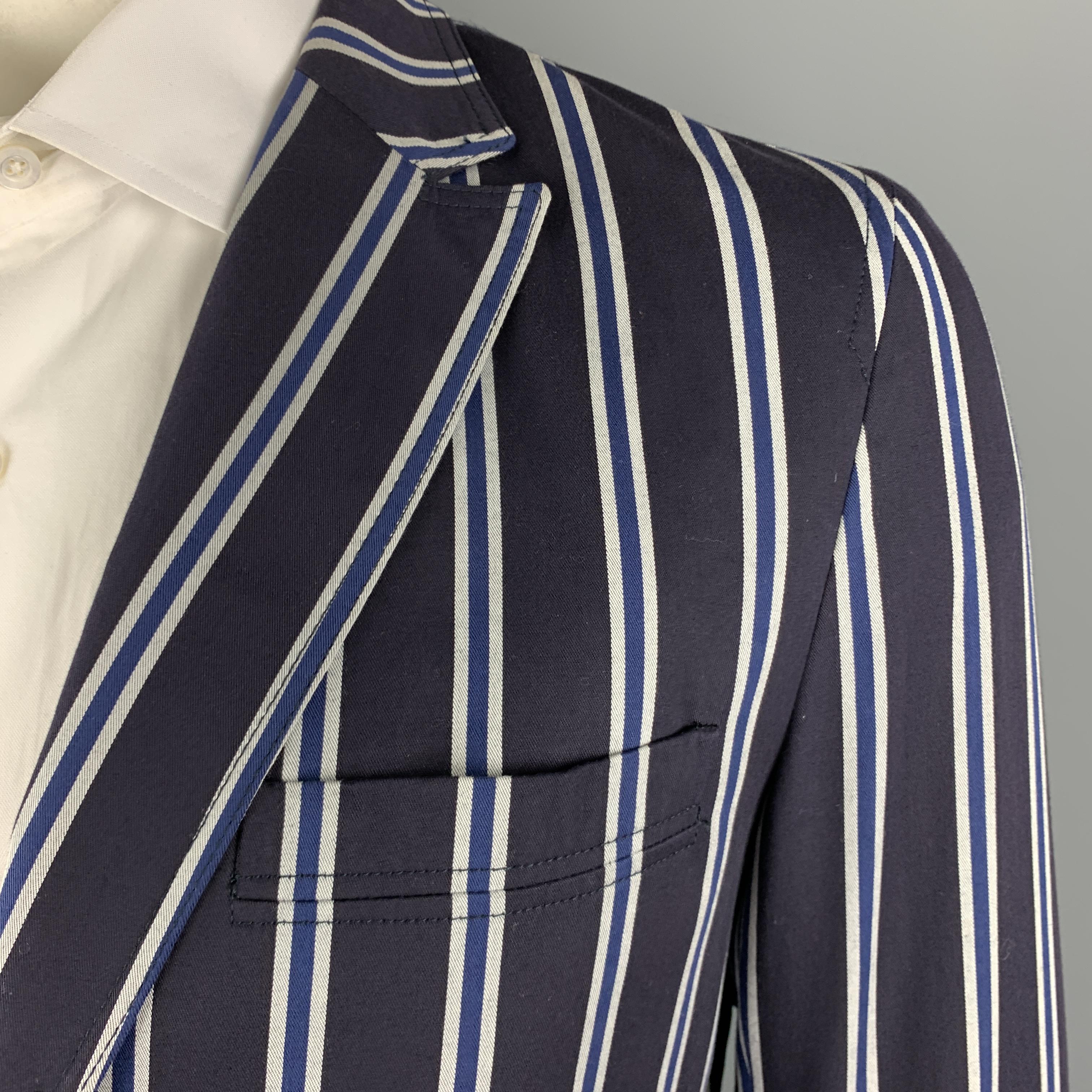 D&G sport coat comes in navy & gray striped twill with a peak lapel, single breasted, two button front, and flap pockets. Made in Italy.

Excellent Pre-Owned Condition.
Marked: IT 52

Measurements:

Shoulder: 18 in.
Chest: 44 in.
Sleeve: 27