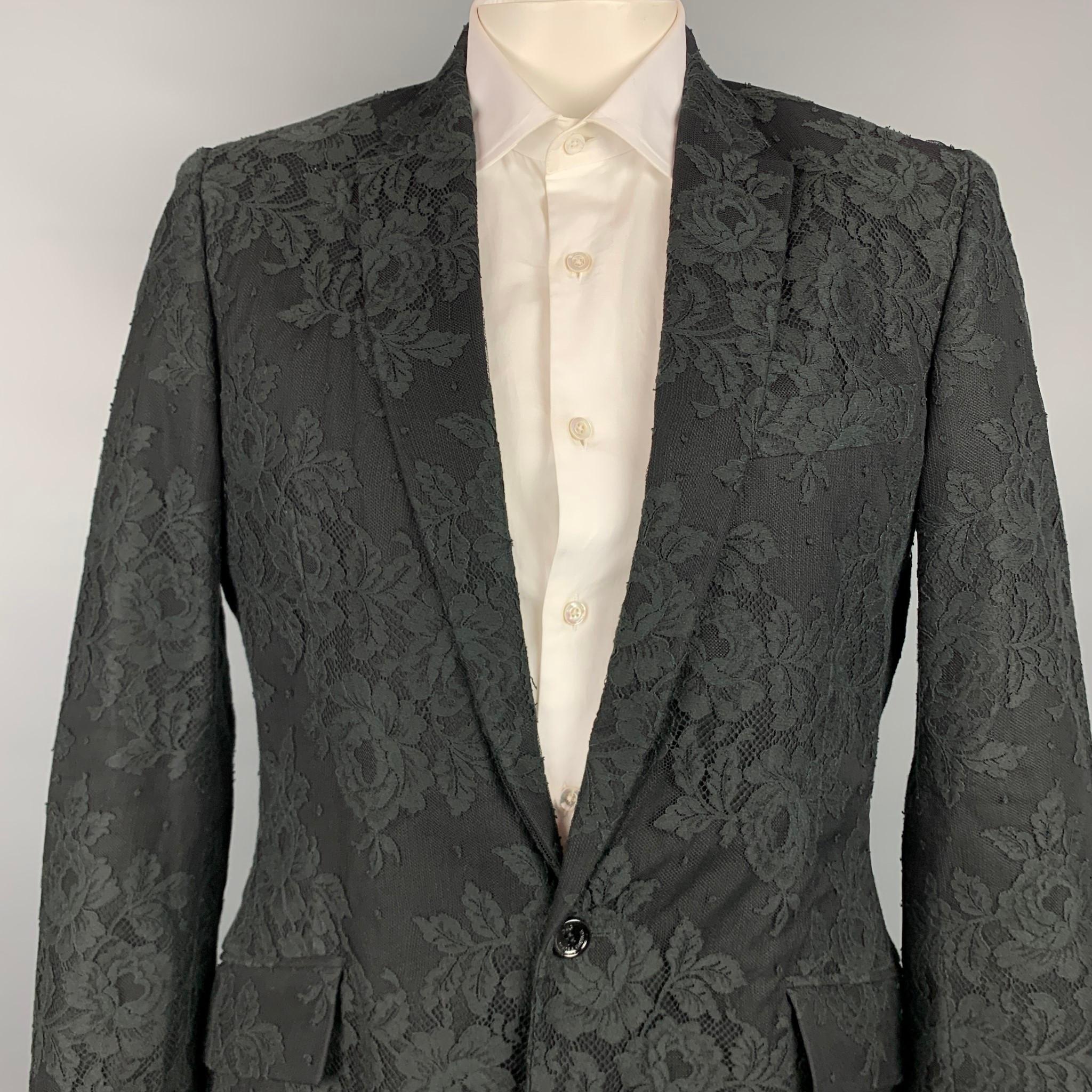 D&G by DOLCE & GABBANA sport coat comes in a black lace material with a full liner featuring a notch lapel, flap pockets, and a single button closure. Made in Italy. 

Very Good Pre-Owned Condition.
Marked: Size tag