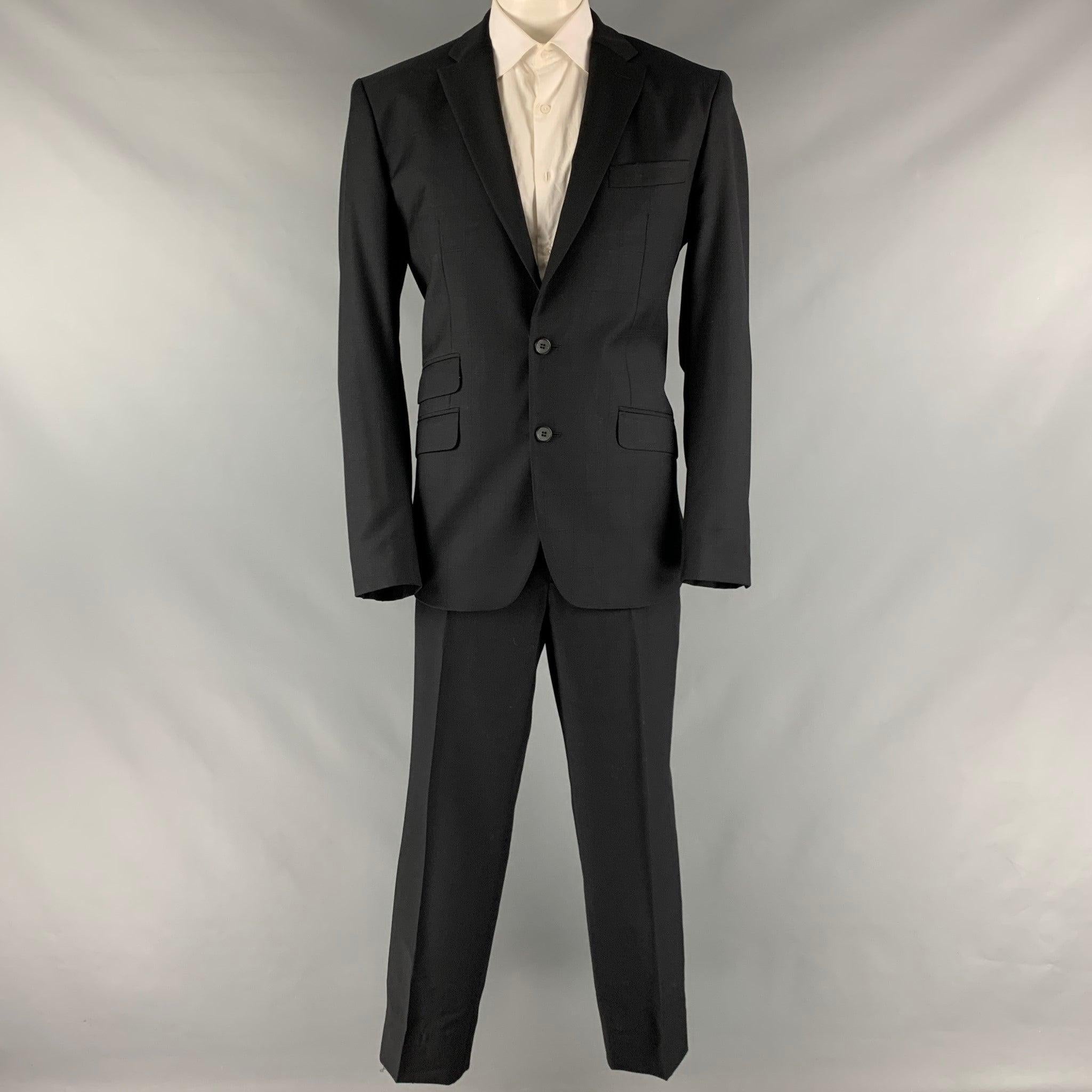 D&G by DOLCE & GABBANA suit comes in a black window pane wool and viscose material with a full liner and includes a single breasted, double button sport coat with a notch lapel and matching flat front trousers. Very Good Pre-Owned Condition. Minor