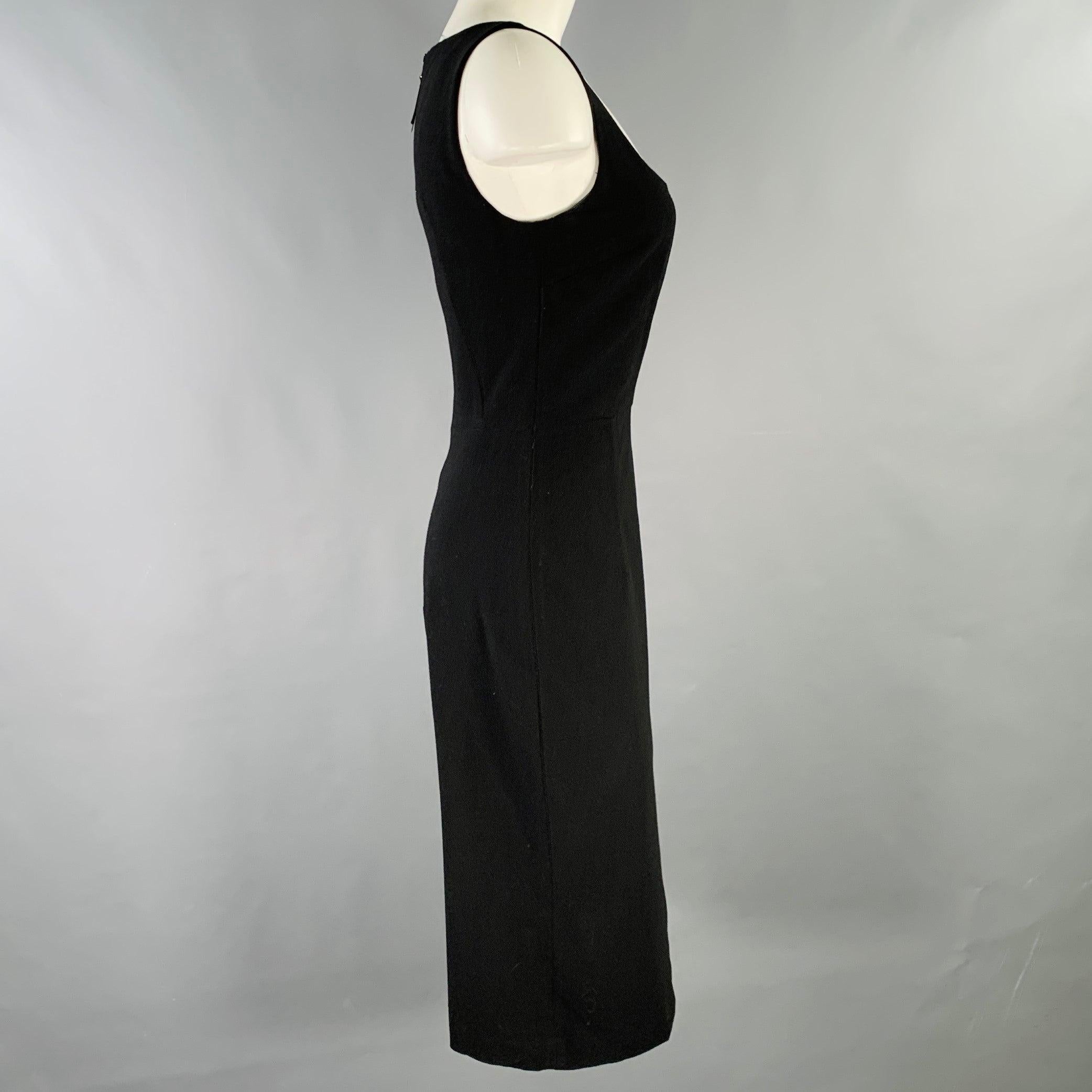 D&G by DOLCE & GABBANA dress
in a black virgin wool blend crepe featuring a sleeveless style, midi length, and back zipper closure.Very Good Pre-Owned Condition. Minor signs of wear. 

Marked:   IT 42 

Measurements: 
 
Shoulder: 12.5 inches Bust: