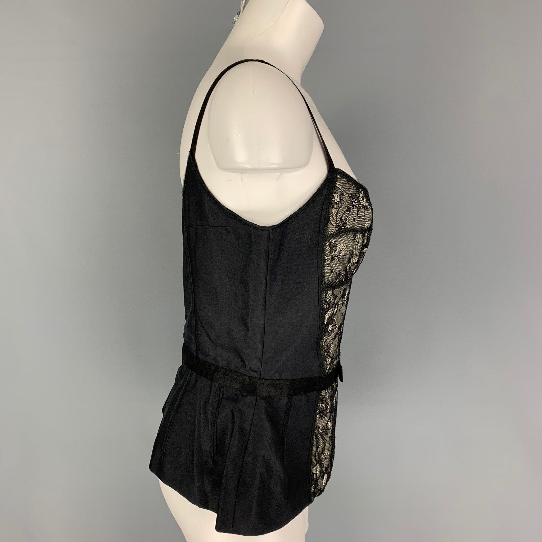 D&G by DOLCE & GABBANA dress top comes in a black lace rayon featuring a bustier style, bow detail, and 
back zip up closure.
Very Good
Pre-Owned Condition. 

Marked:   44 

Measurements: 
  Bust: 30 inches  Length: 13.5 inches 

  
  
 
Reference: