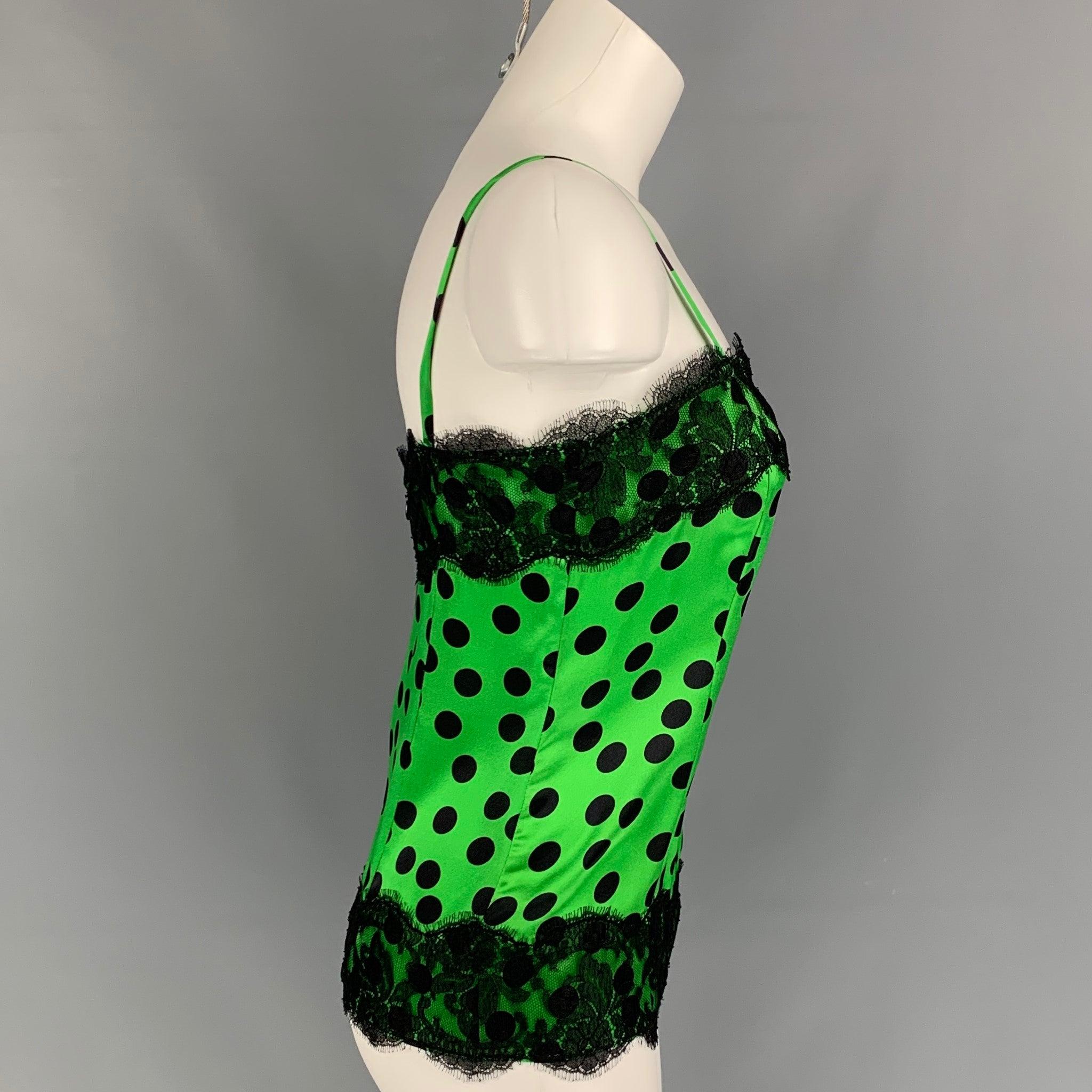 D&G by DOLCE & GABBANA casual top comes in a green & black polka dot silk featuring a lace trim design, spaghetti straps, and a back zip up closure.
Excellent
Pre-Owned Condition. 

Marked:   44 

Measurements: 
  Bust: 32 inches  Length: 14 inches
