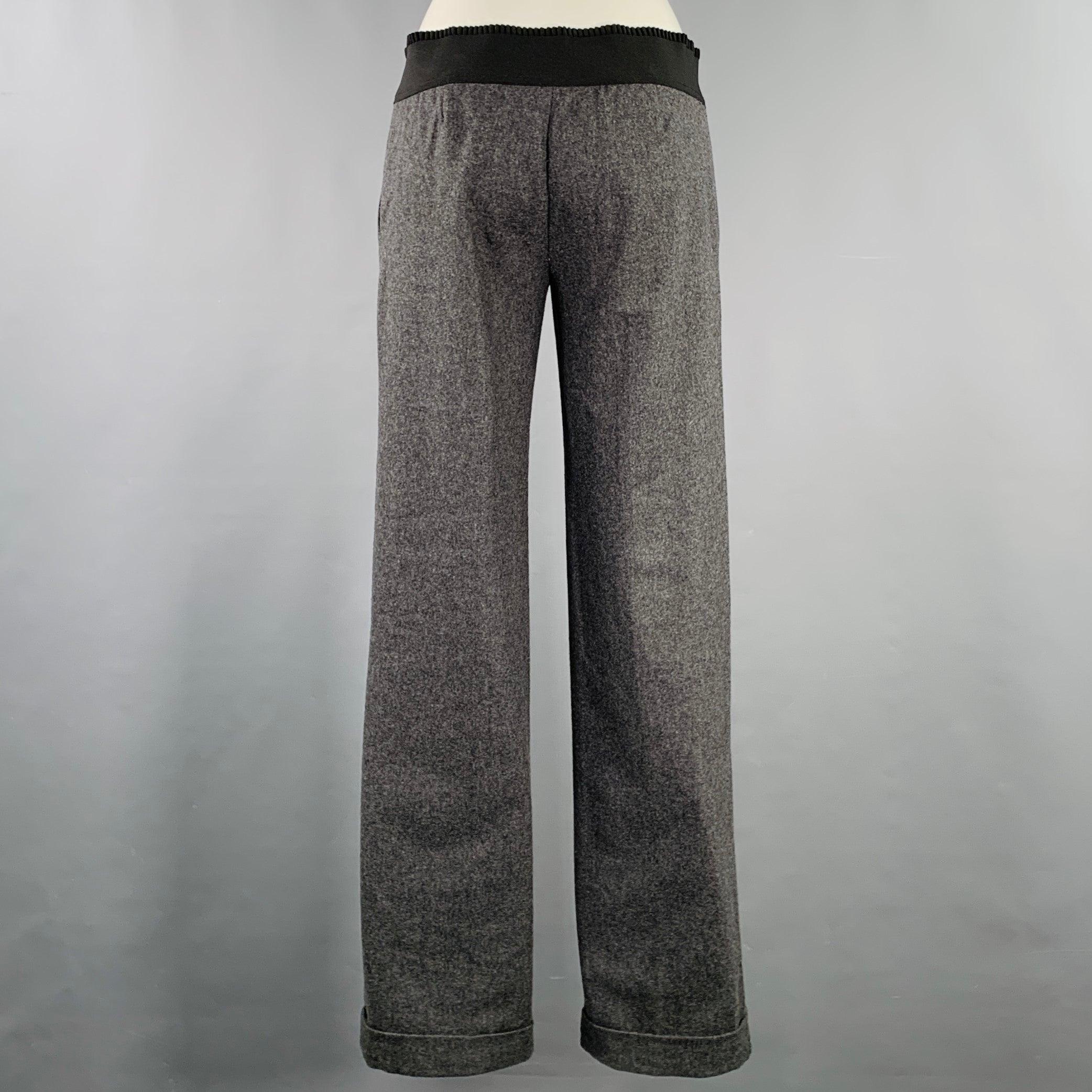 D&G by DOLCE & GABBANA dress pants
in a grey wool blend featuring a black ribbon trim waistband, cuffed design, and zip fly closure.Excellent Pre-Owned Condition. 

Marked:   IT 40 

Measurements: 
  Waist: 31 - 34 inches Rise: 6 inches Inseam: 32