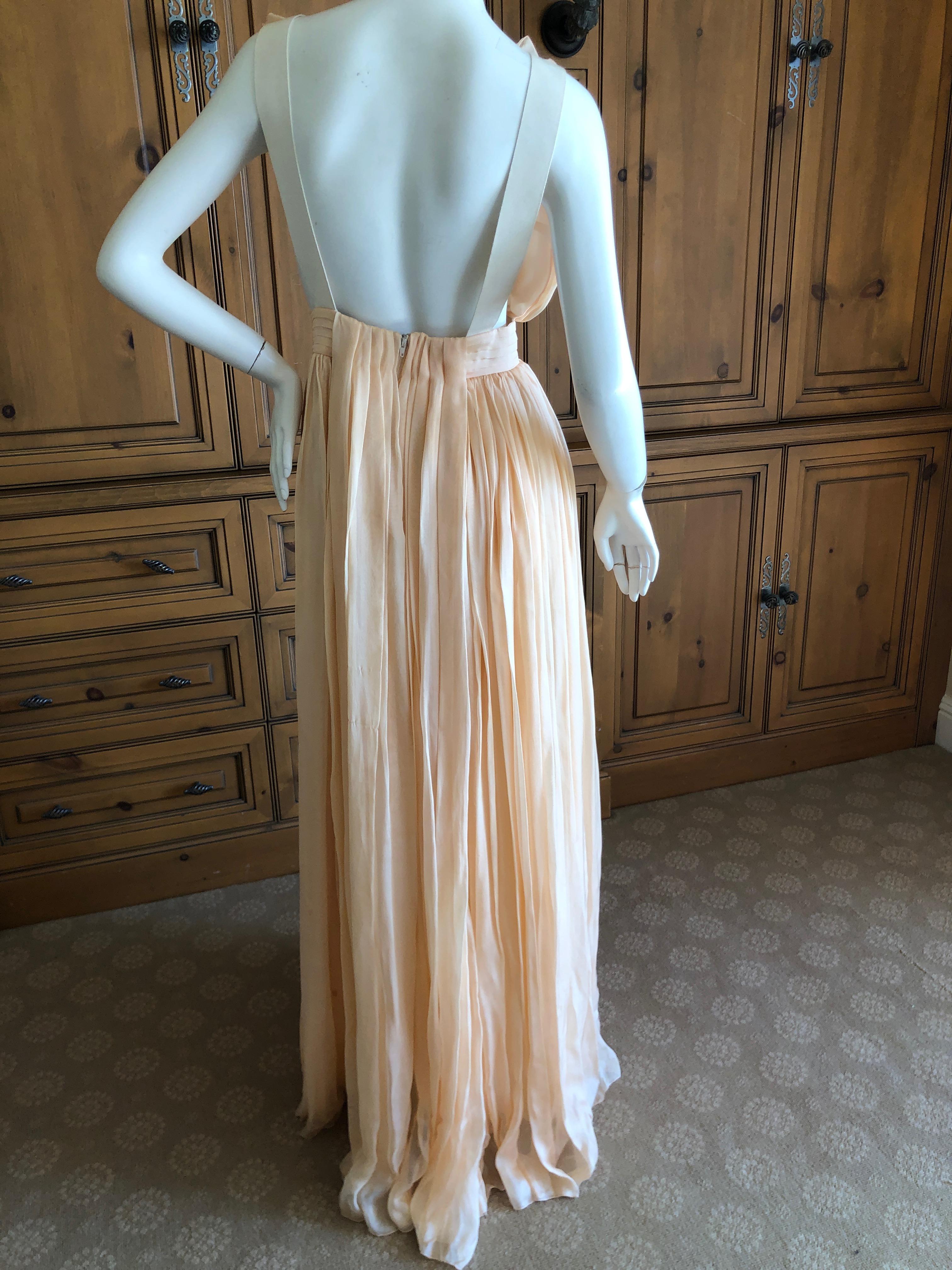 D&G Dolce & Gabbana Romantic Apricot Pink Silk Flowing Low Cut Evening Dress .
This is so beautiful with miles of flowing silk.
There are some holes in the lower back of the dress, see last photos.They are not apparent , they are lost in the