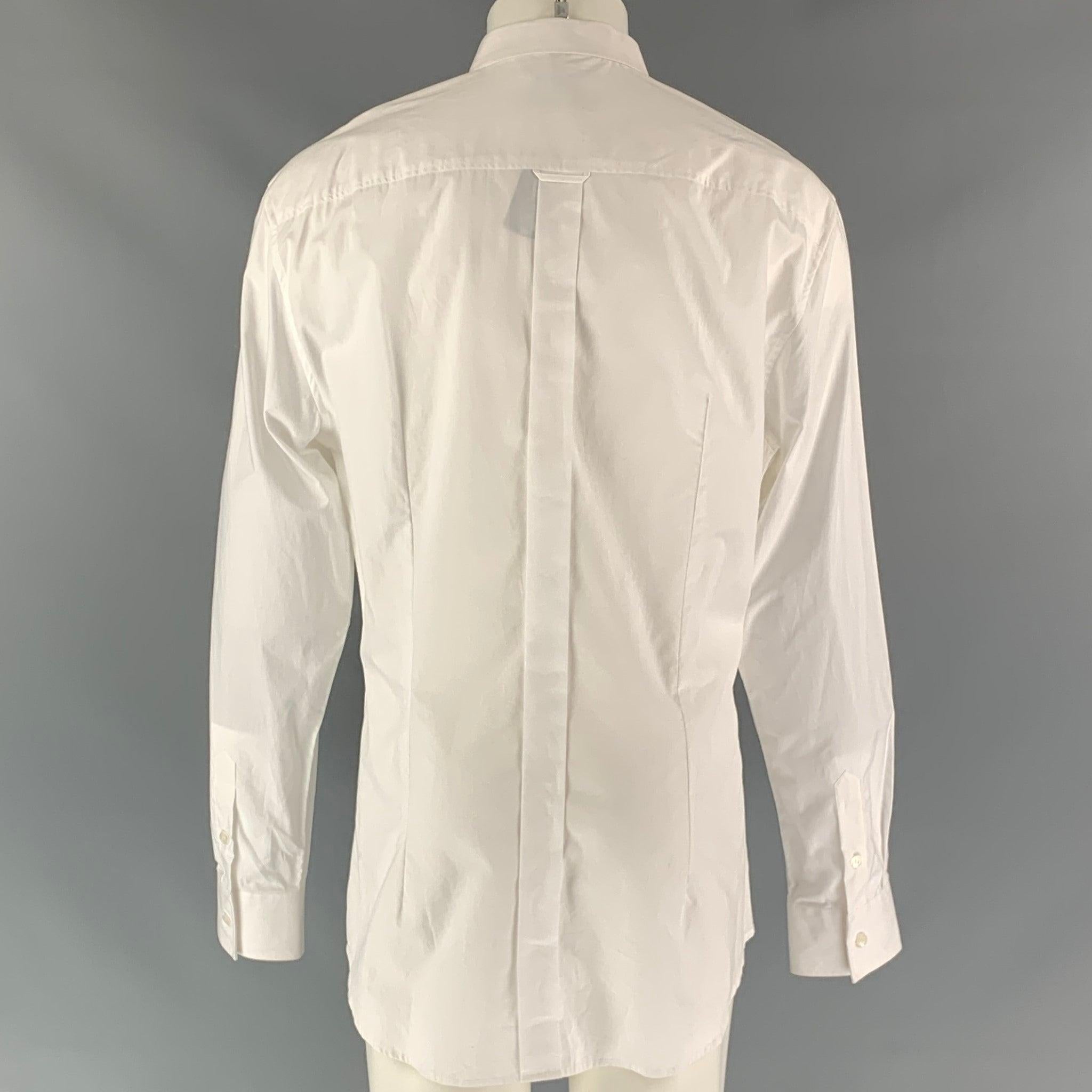 D&G DOLCE & GABBANA long sleeve dress shirt comes in white cotton fabric, button up closure, straight point collar and one button square sleeve cuff features patch pockets.
New with Tags. 

Marked:   48
 

Measurements: 
  
Shoulder: 21 inChest: 48