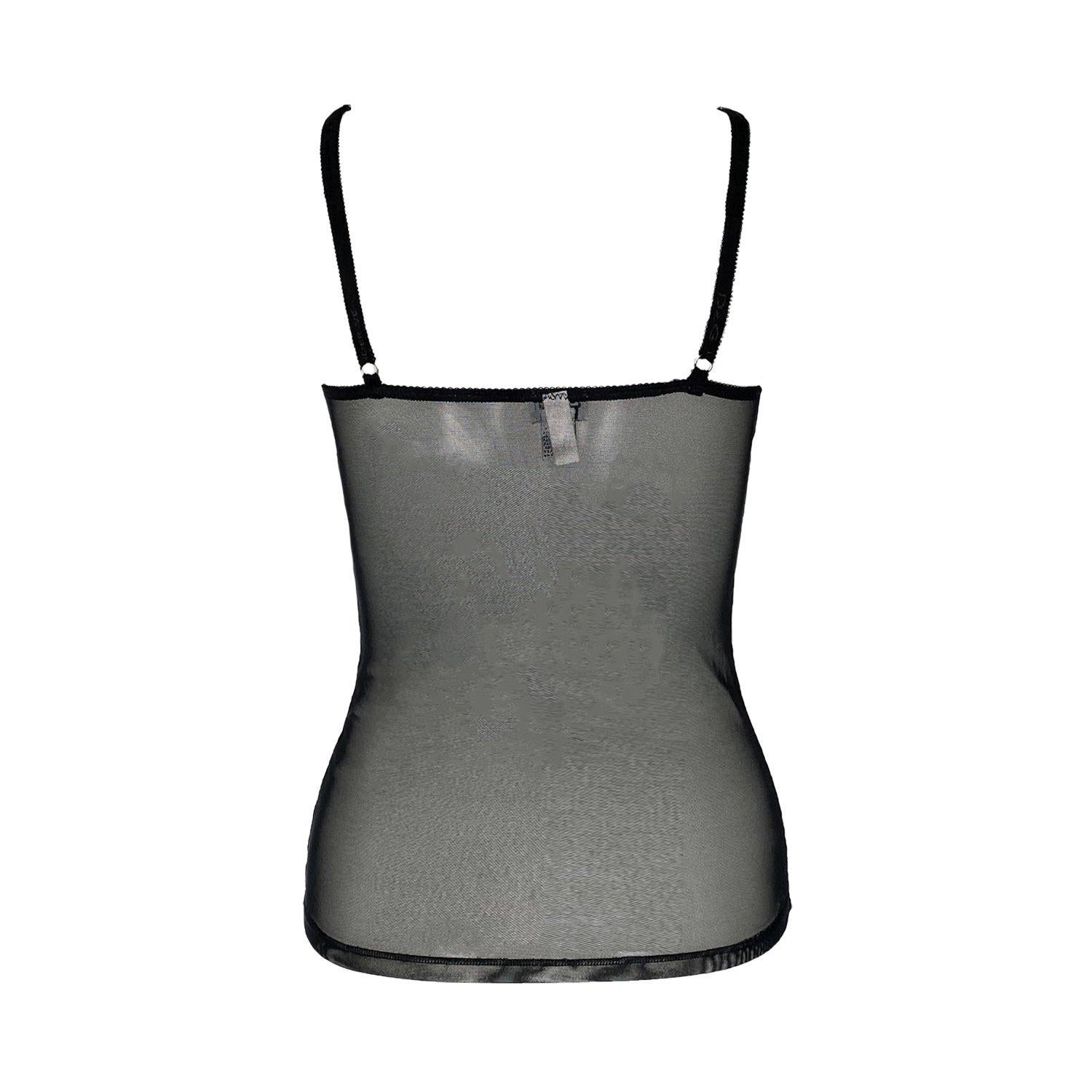 Iconic vintage black D&G by Dolce and Gabbana sheer lace cami from the early 2000s in a y2k lingerie style. Featuring lace detailing in a silver glitter shine to the bustier and cups. D&G italic signature metal logo in silver charm to the cup strap.