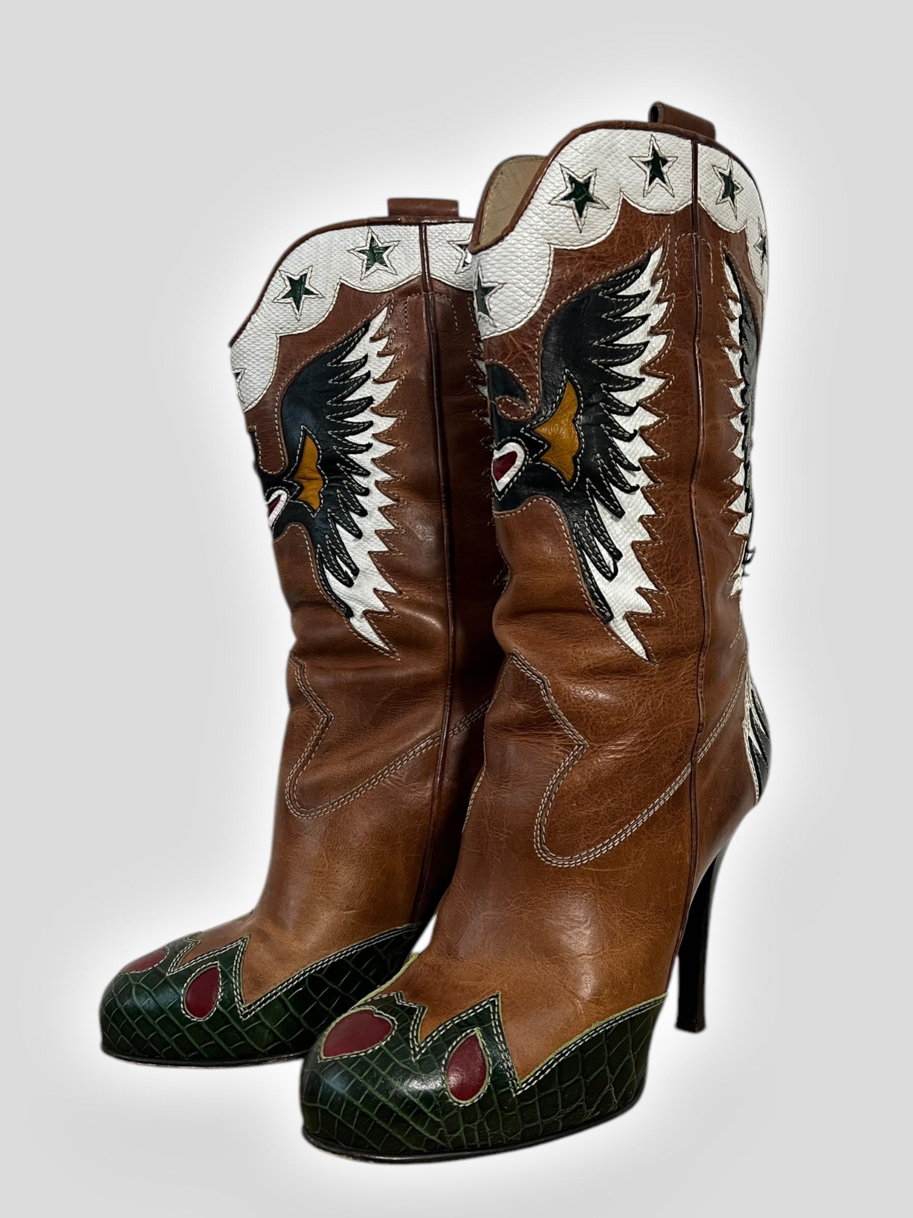 
A striking fusion of Western influences and high-fashion edge, these Dolce & Gabbana (D&G) cowboy boots bring bold attitude with their 4.5-inch stiletto heel. Crafted from rich brown leather, they feature an intricate butterfly motif across the toe