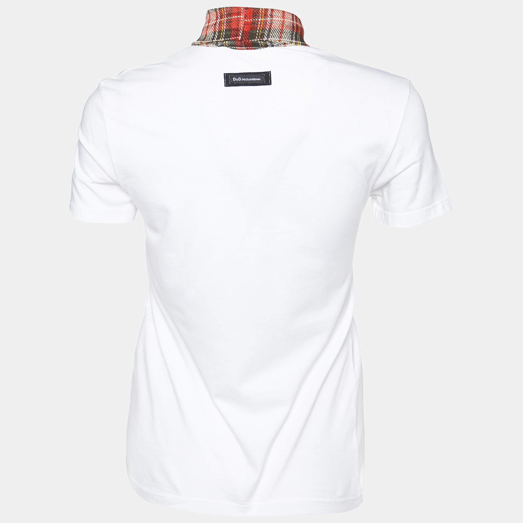 Embrace timeless elegance with the D and G T Shirt. Crafted with meticulous attention to detail this exquisite piece seamlessly blends luxury and comfort. The soft cotton fabric caresses the skin while the delicate silk scarf trim adds a touch of