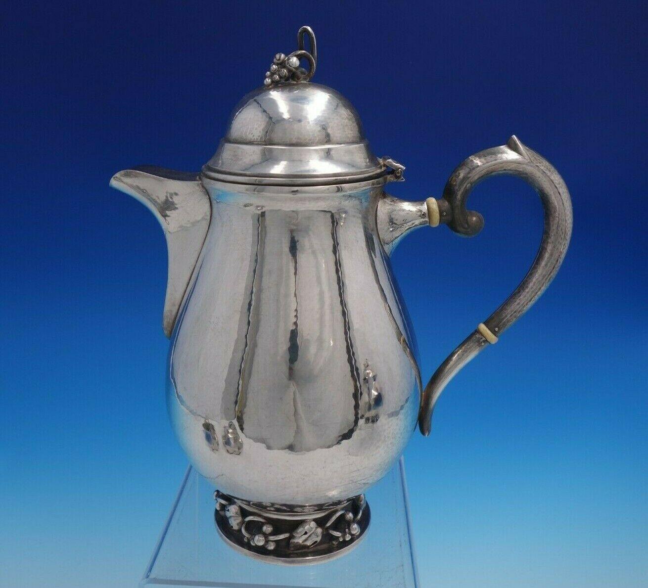 DGH goldsmith

Beautiful DGH goldsmith sterling silver 4-piece tea set. This set is handwrought and features a grape and leaf motif. It includes:

1 - Coffee pot: Measures 8