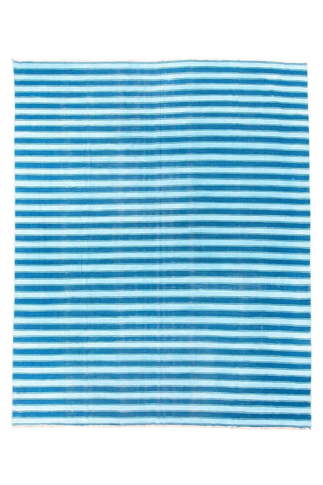 All blue denim and light blue stripes, with allover dimensional adjustability. Beach and lake house special. Washable. All cotton. As new condition.

Rug Size
9'7x11'10