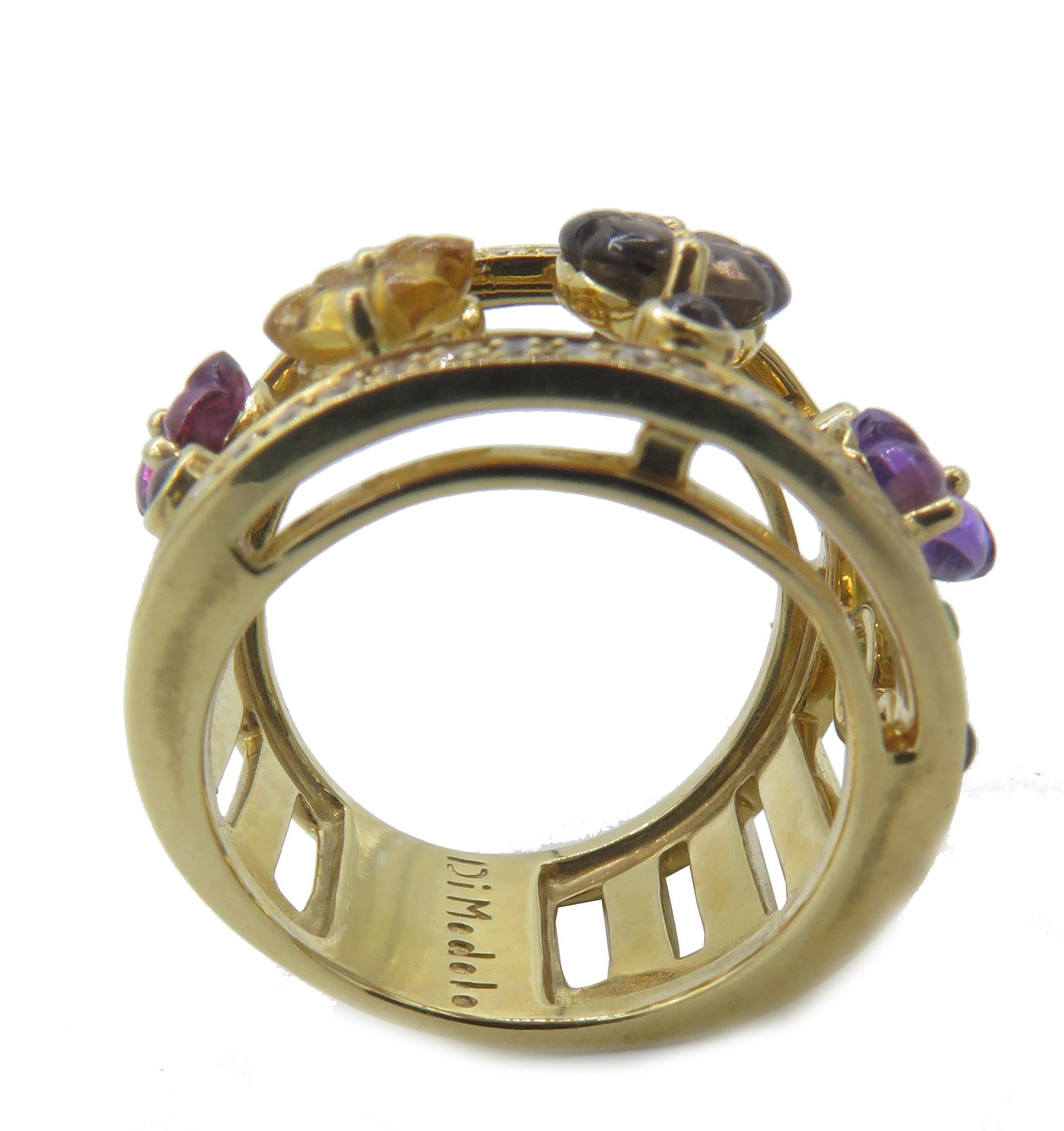 This stunning 18k gold Tempia Ring is from the Di Modolo Italian Fine Jewelry Collection. The outer edges of the ring are outlined with 0.35cts of pave white diamonds. The beautifully crafted multi-stone designs in the center of the band contain