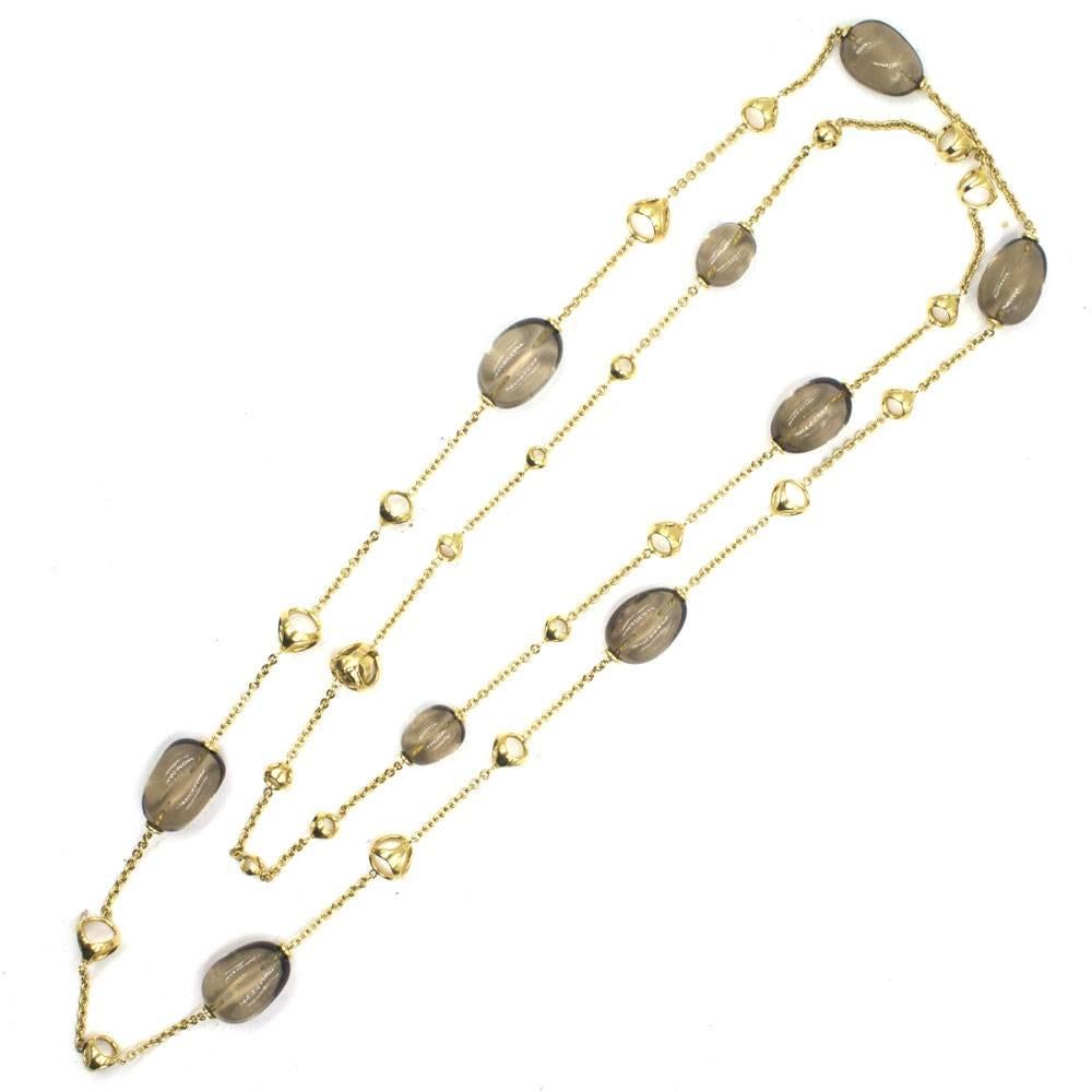 Beautiful 18 karat yellow gold and smokey topaz link necklace by Di Modola. The 42 inch necklace is part of the Triadora collection. Yellow gold open balls and links are connected to oval smokey topaz gemstones. The neutral colors allow you to wear