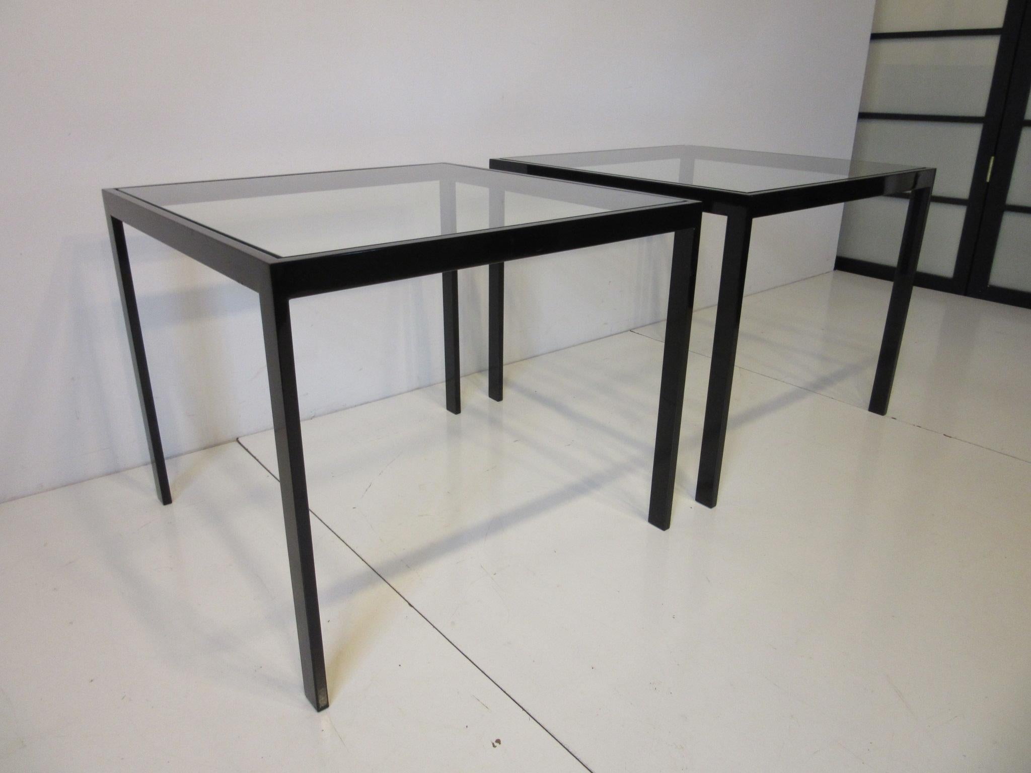 A pair of anodized black metal framed side tables with glass inserted tops, retains the manufactures serial numbered label for these hard to find pieces. Great for any interior with that period black Porsche styled finish found in the 1970s and