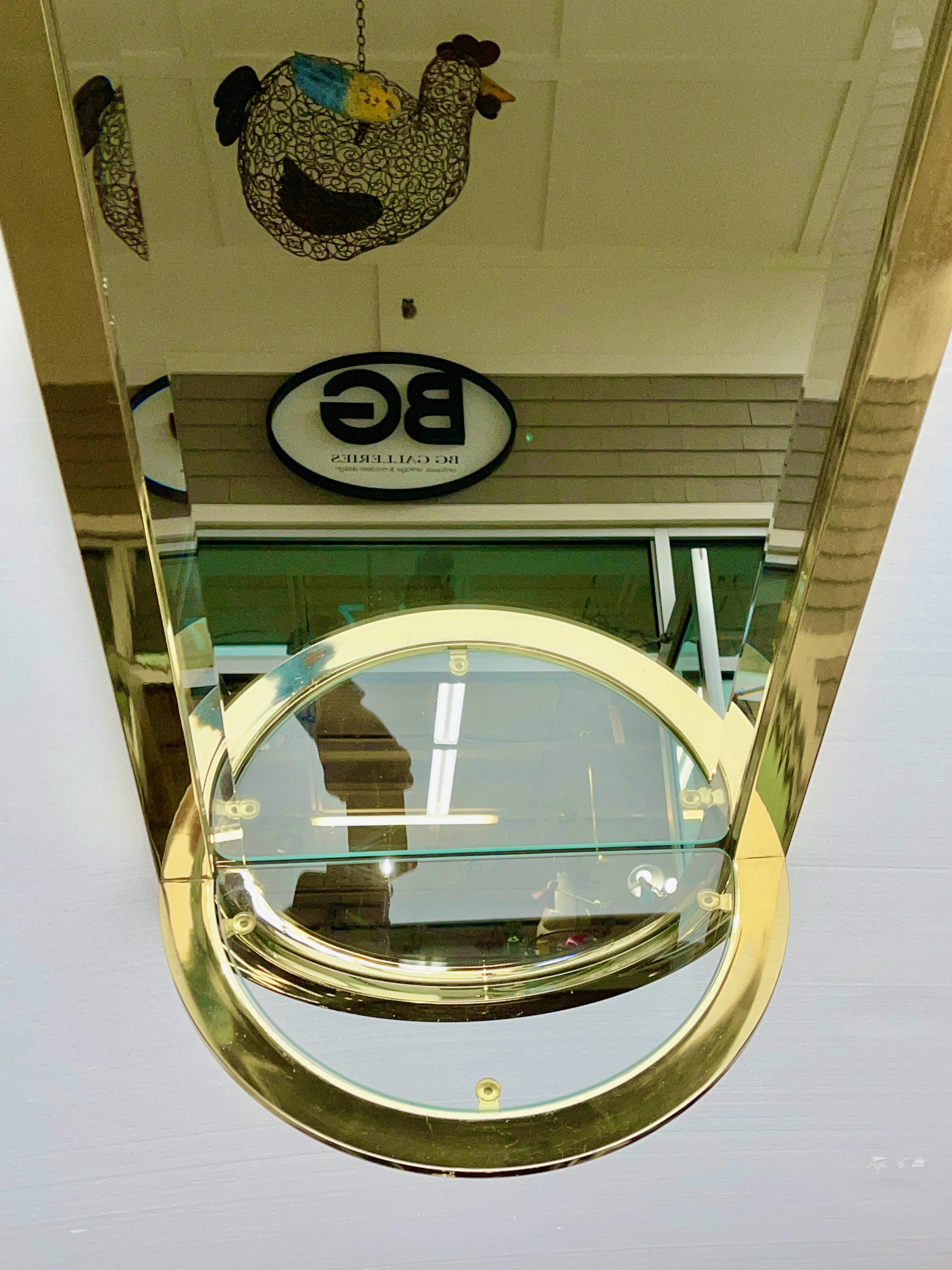 Late 20th Century DIA Design Institute America Brass Racetrack Oval Mirror with Demilune Shelf For Sale
