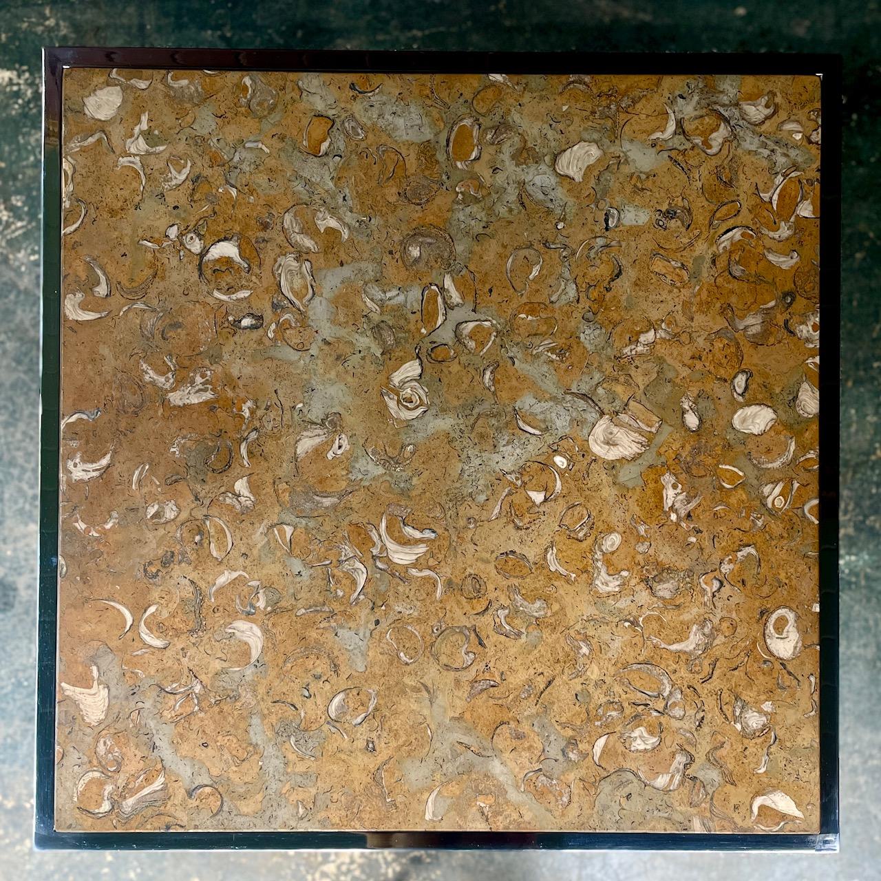 Portuguese Fossilized Stone Top on Chromed Steel Base, retains DIA paper label, and source of stone label.  One natural divet to edge, and one small chip to edge, both on same side, pictured.

Total H 28 5/8 and Ground to Bottom edge of table H 26