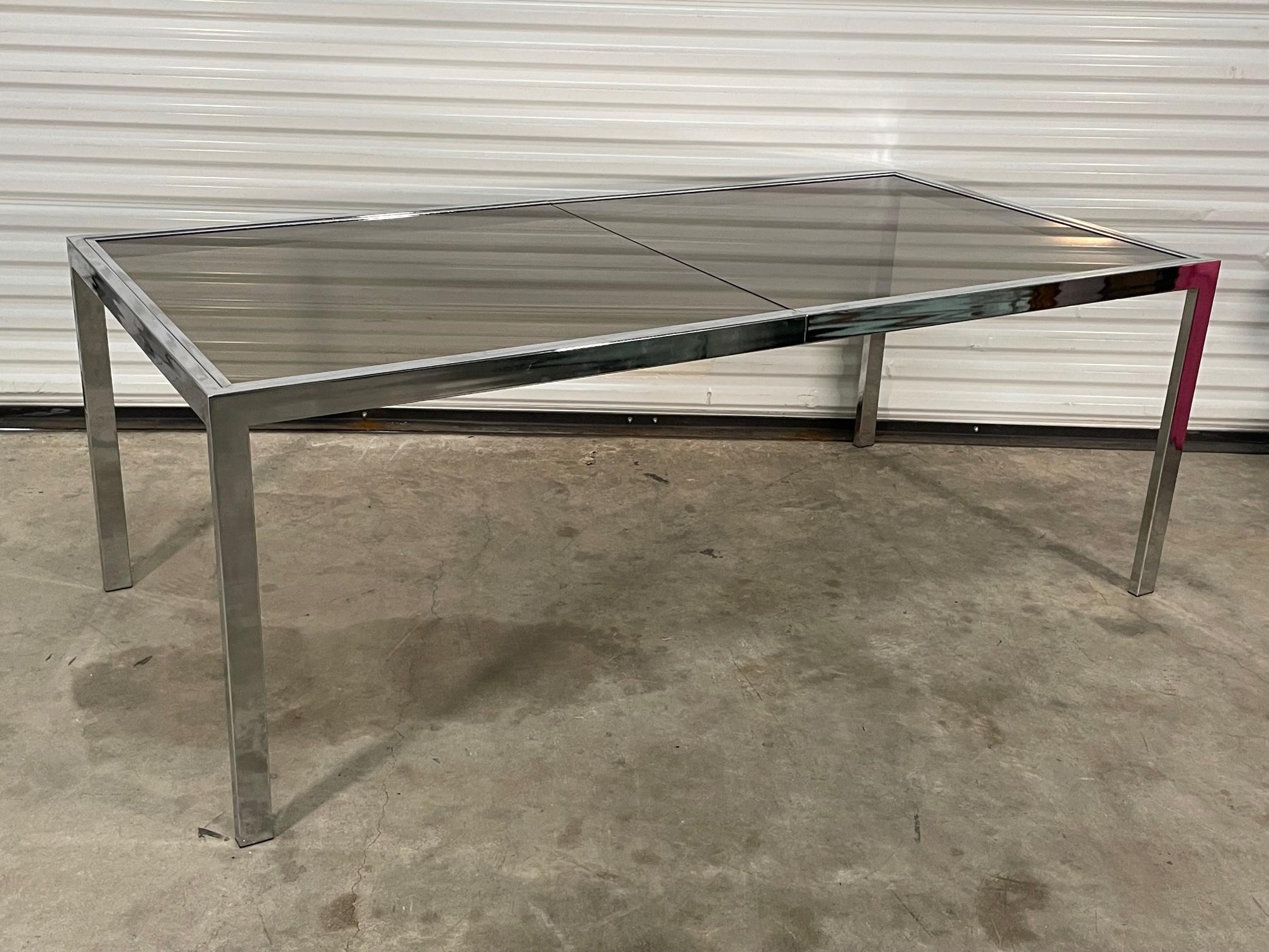 Mid century chrome dining table by Milo Baughman for Design Institute of America features smoked glass and a chrome frame. Good condition with imperfections consistent with age, see photos for condition details. We are also offering the matching