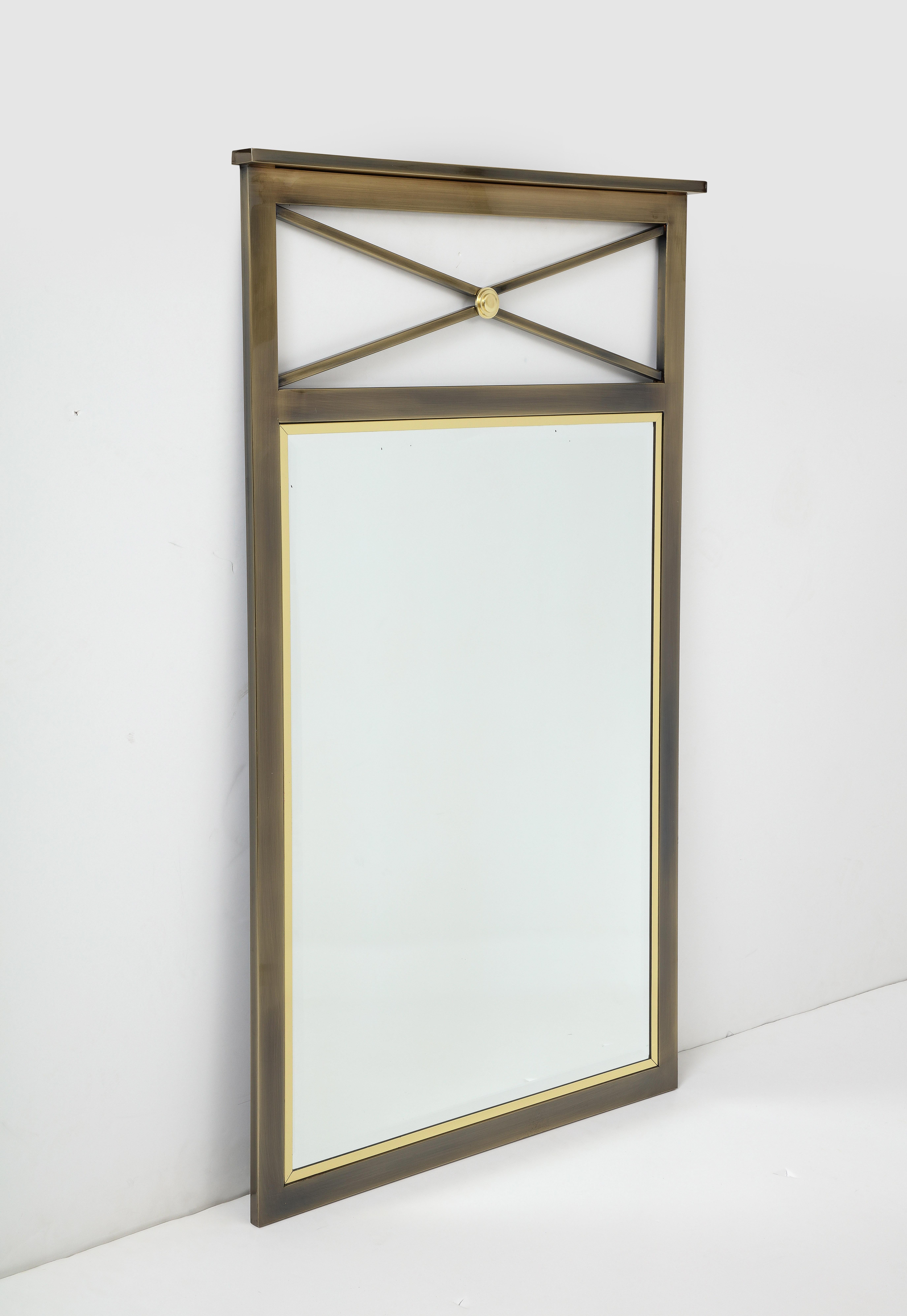 Midcentury neoclassical influenced mirror surrounded by brass trim and a bronze frame, made by Design Institute of America.