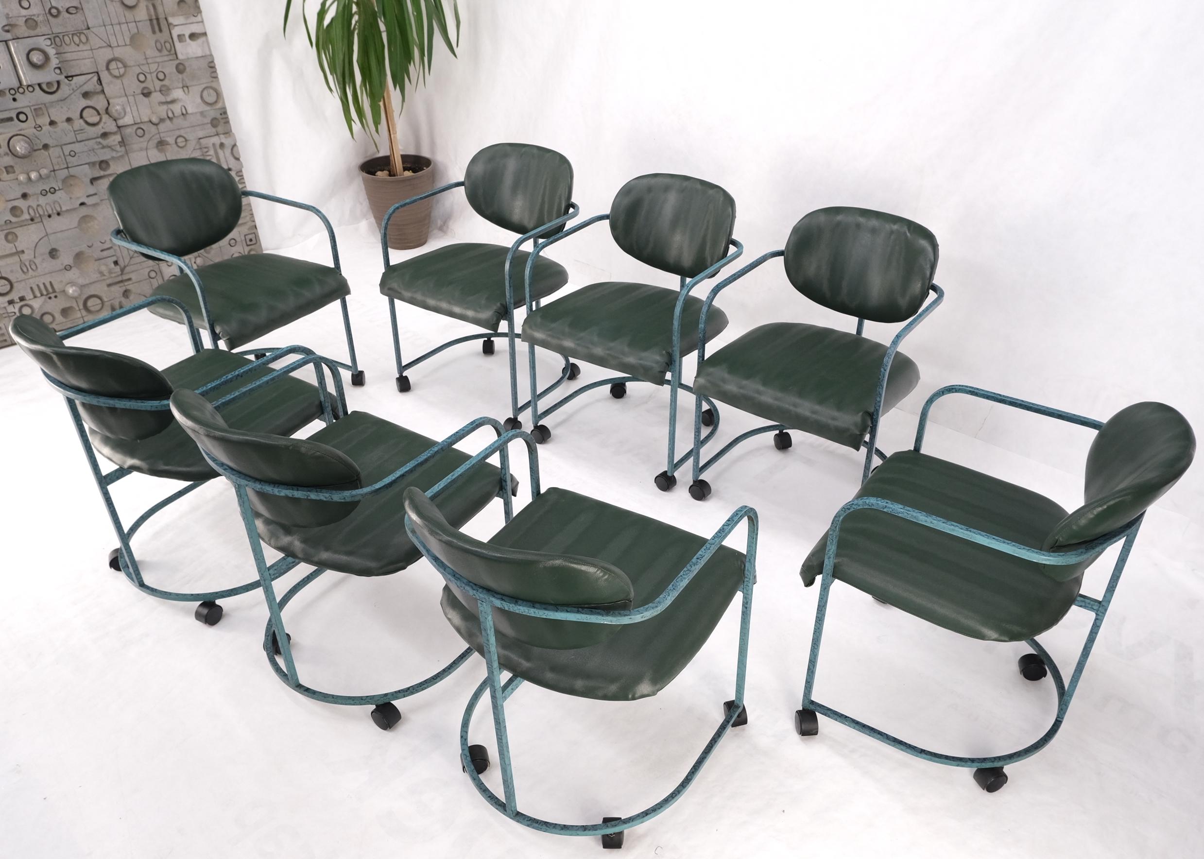 DIA set of green upholstery mid century dining office chairs on wheels.