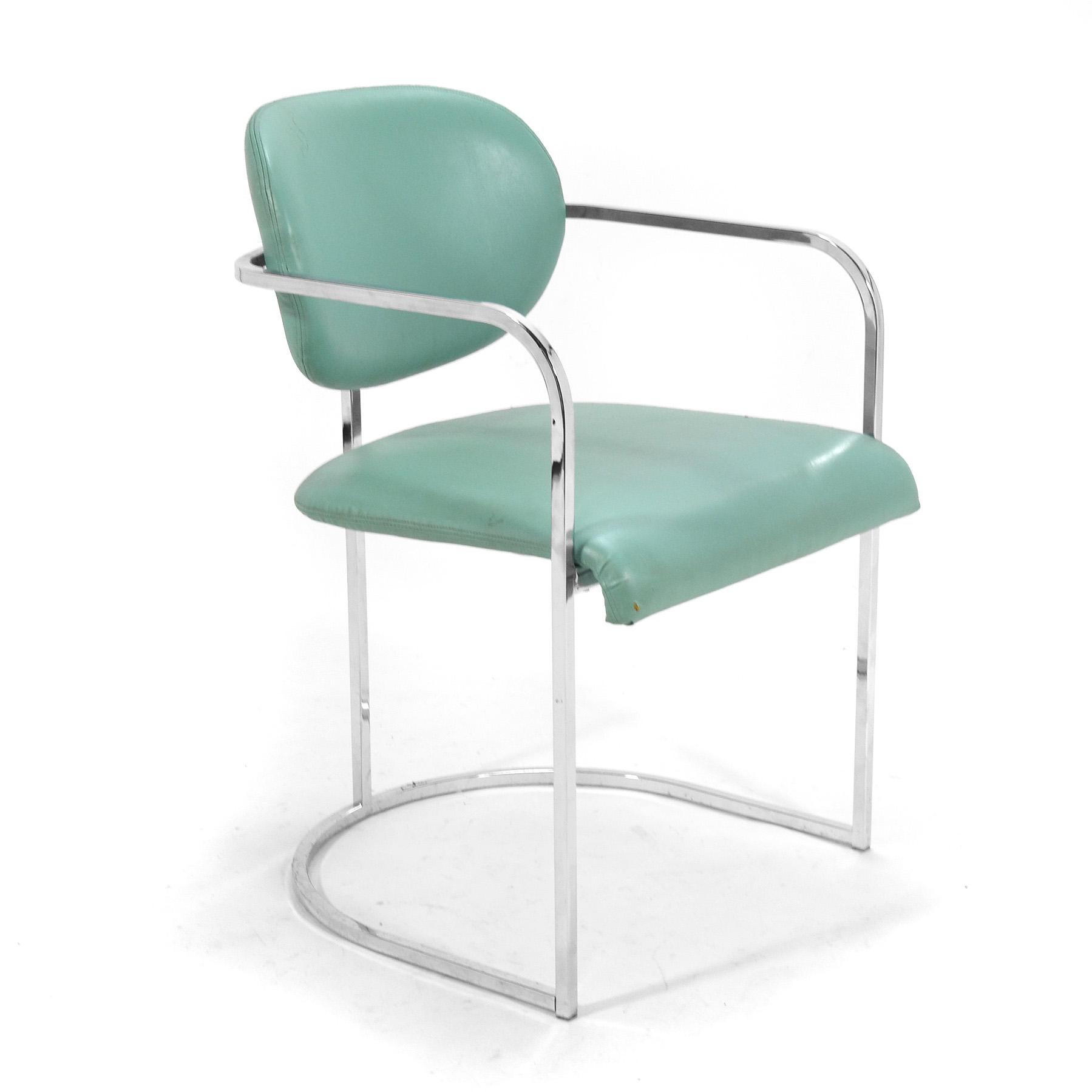 This set of armchairs by the Design Institute America have frames of chrome-plated steel which support upholstered seats and backs, giving them a floating appearance.
They currently retain their original turquoise upholstery, but are ready for