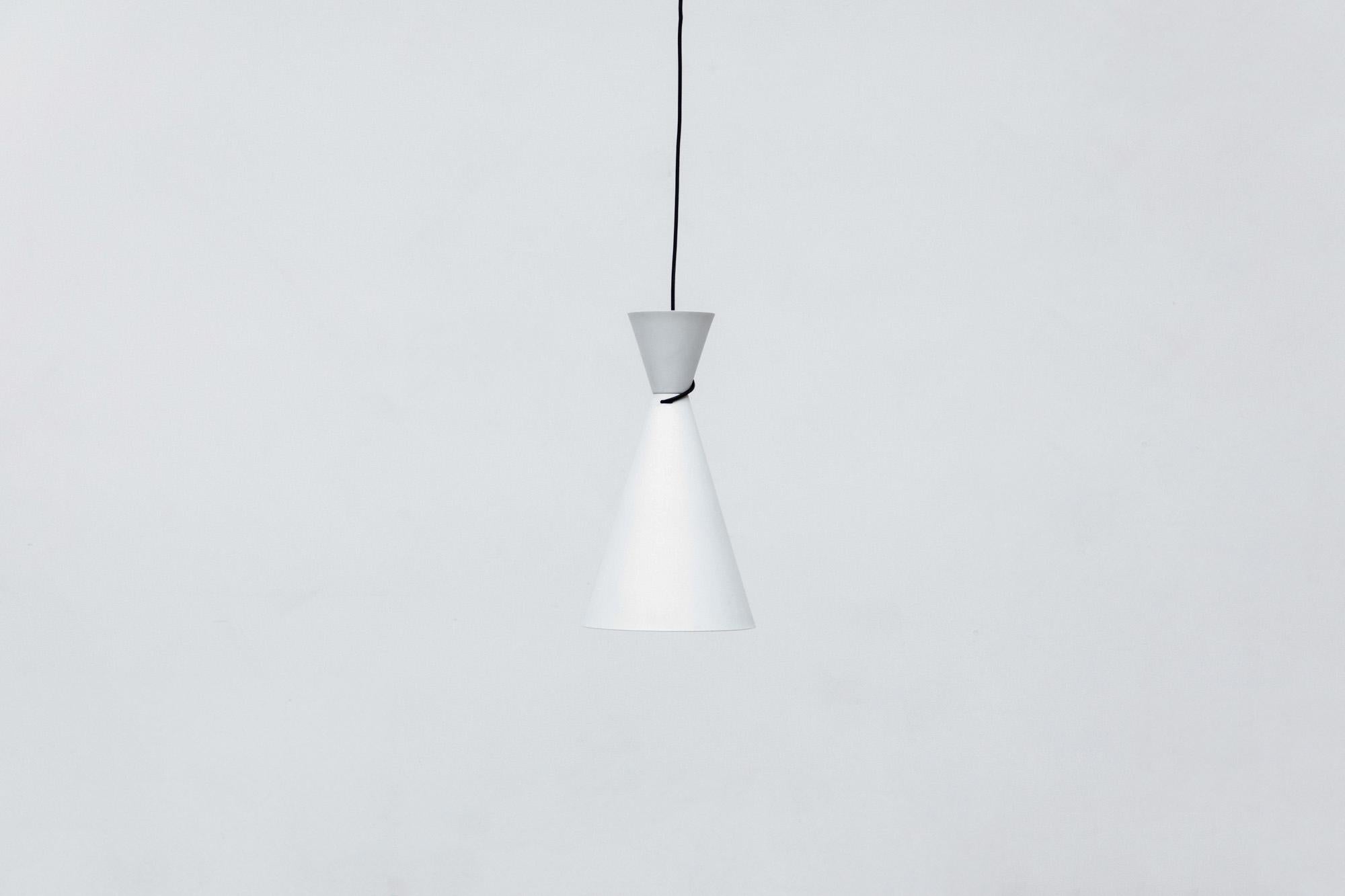 'Diablo' style white enameled metal pendant lamp with black cloth wrap around cord. In good original condition, with minimal wear consistent with age and use.