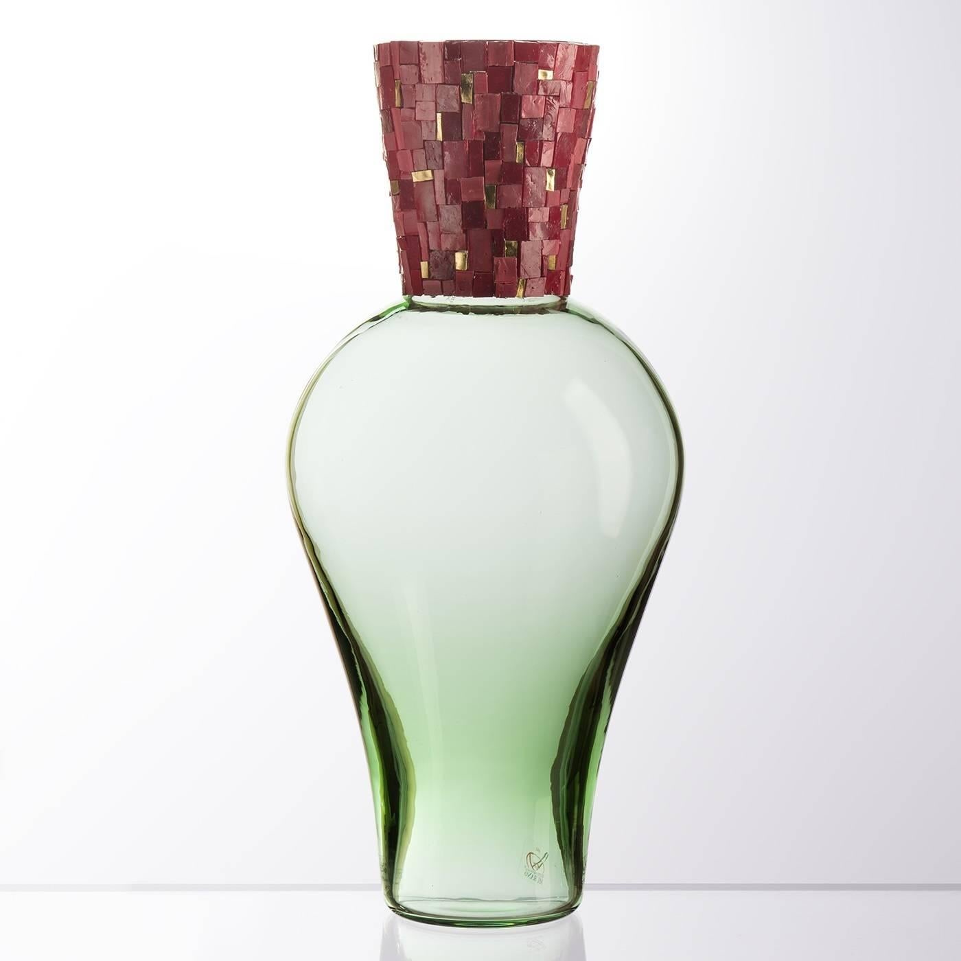 Elegant and unique, this breathtaking Murano mouth-blown glass vase is a perfect piece to brighten any interior thanks to the graceful mosaic band that adorns its neck. The Amphora-shape body is made of Murano glass in a delicate green shade that