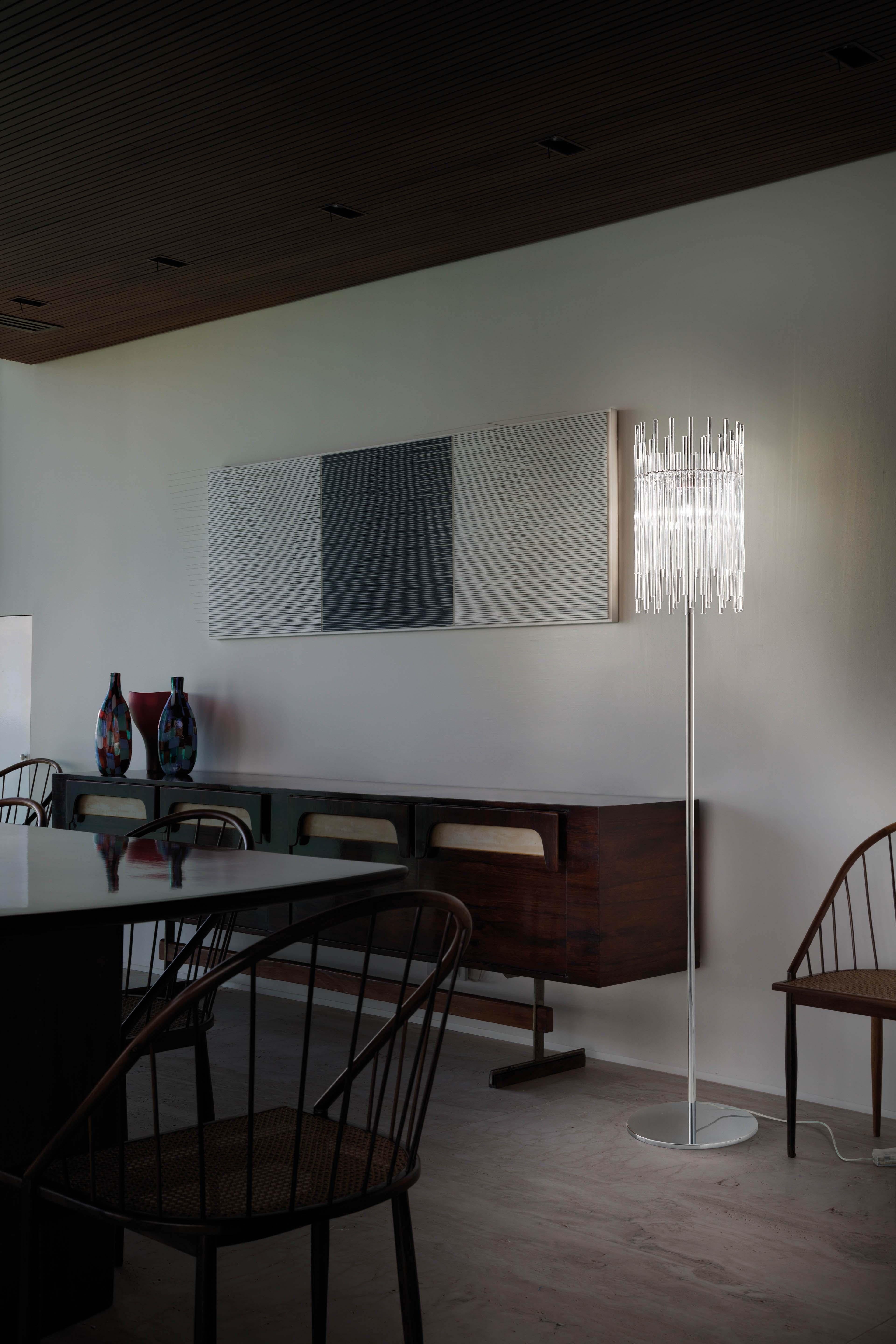 Diadema is a lighting system based on a single element, the rod of pure glass. It takes advantage of the way it reflects and transmits the light, while offering a sense of movement by using rods of different sizes. The metal body allows to offer