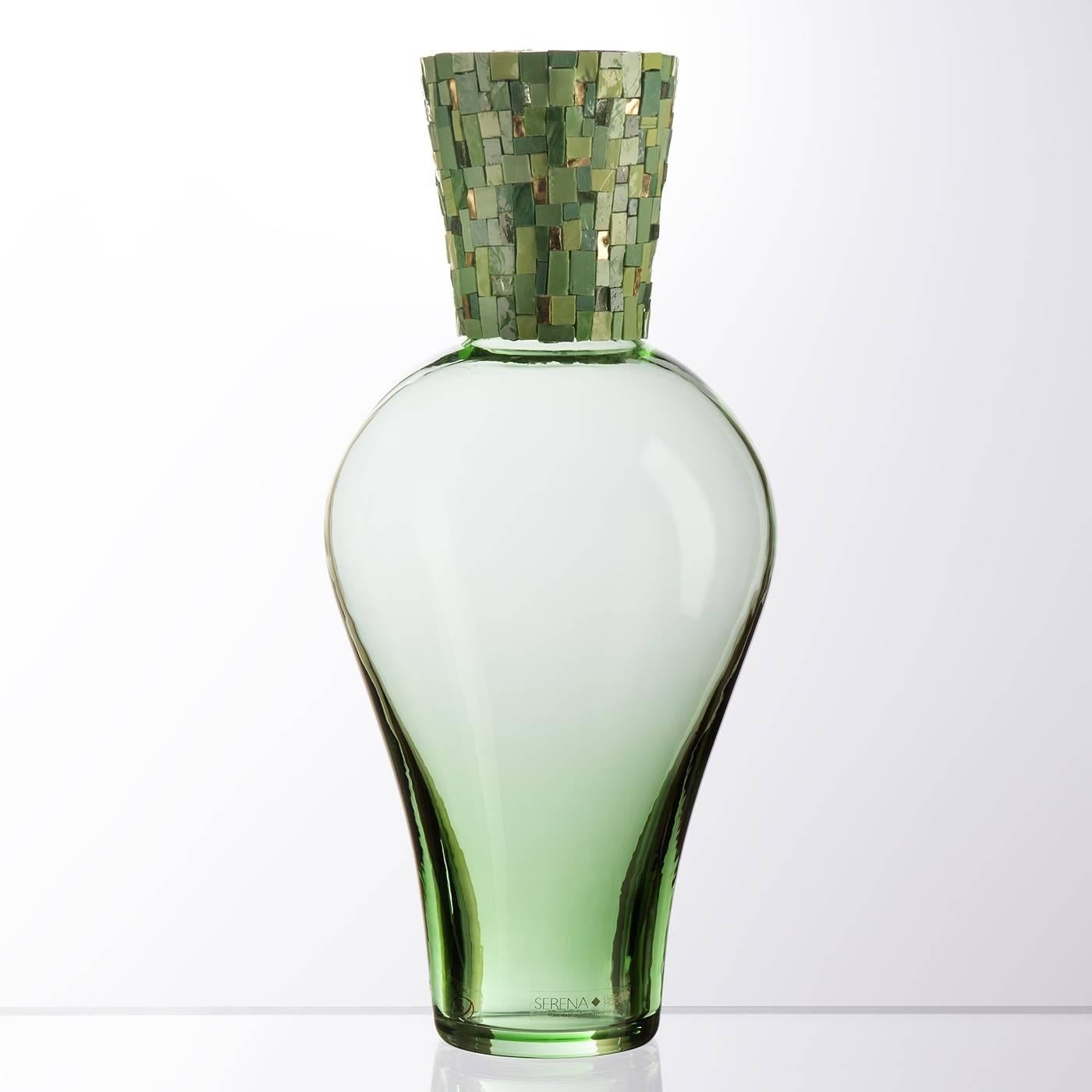 The tone-on-tone effect of the mosaic accents against the transparent sinuous body of this piece infuse a sense of rich elegance to this striking Amphora-shaped Murano green mouth-blown glass with a striking mosaic of tesserae made of gold foil and