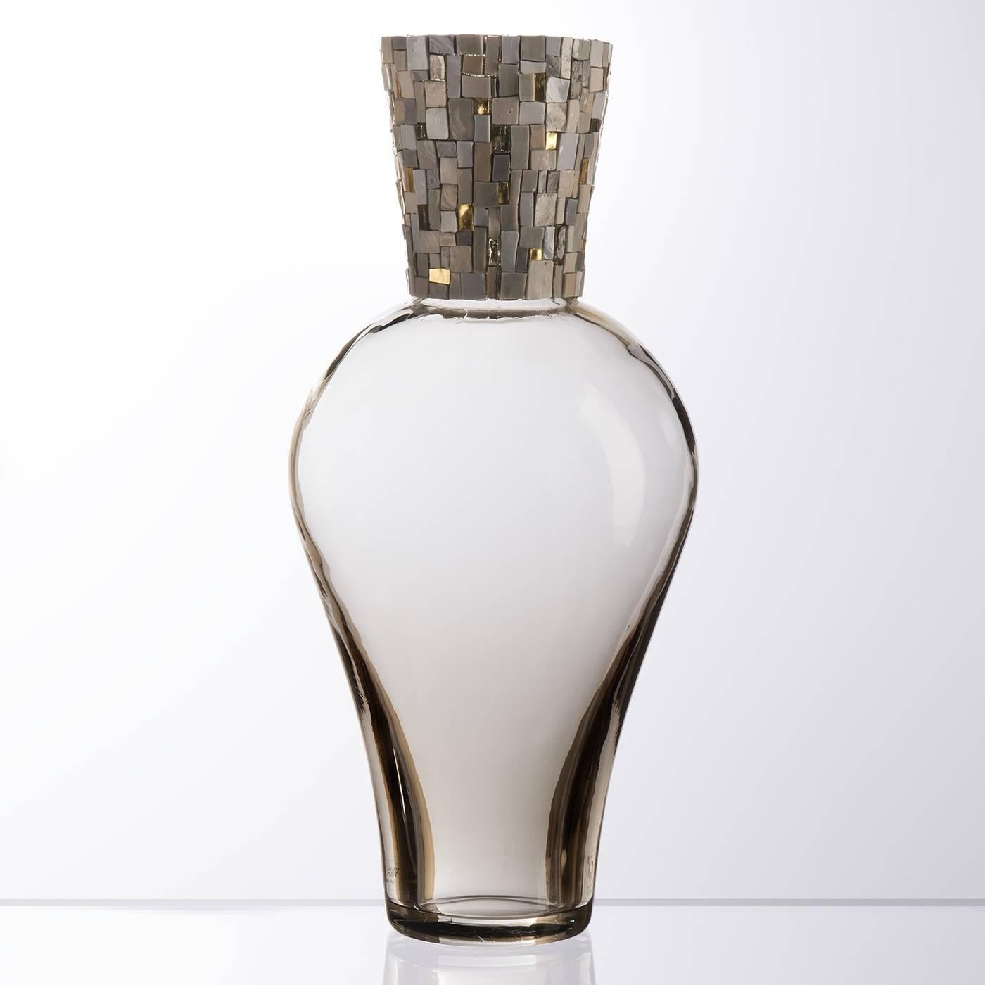 Simple yet elegant, this Murano mouth-blown vase is crafted entirely by hand using traditional glass-making methods by Murano master artisans. Its amphora-shaped body is made of a delicate grey color and features a distinctive mosaic detail, created