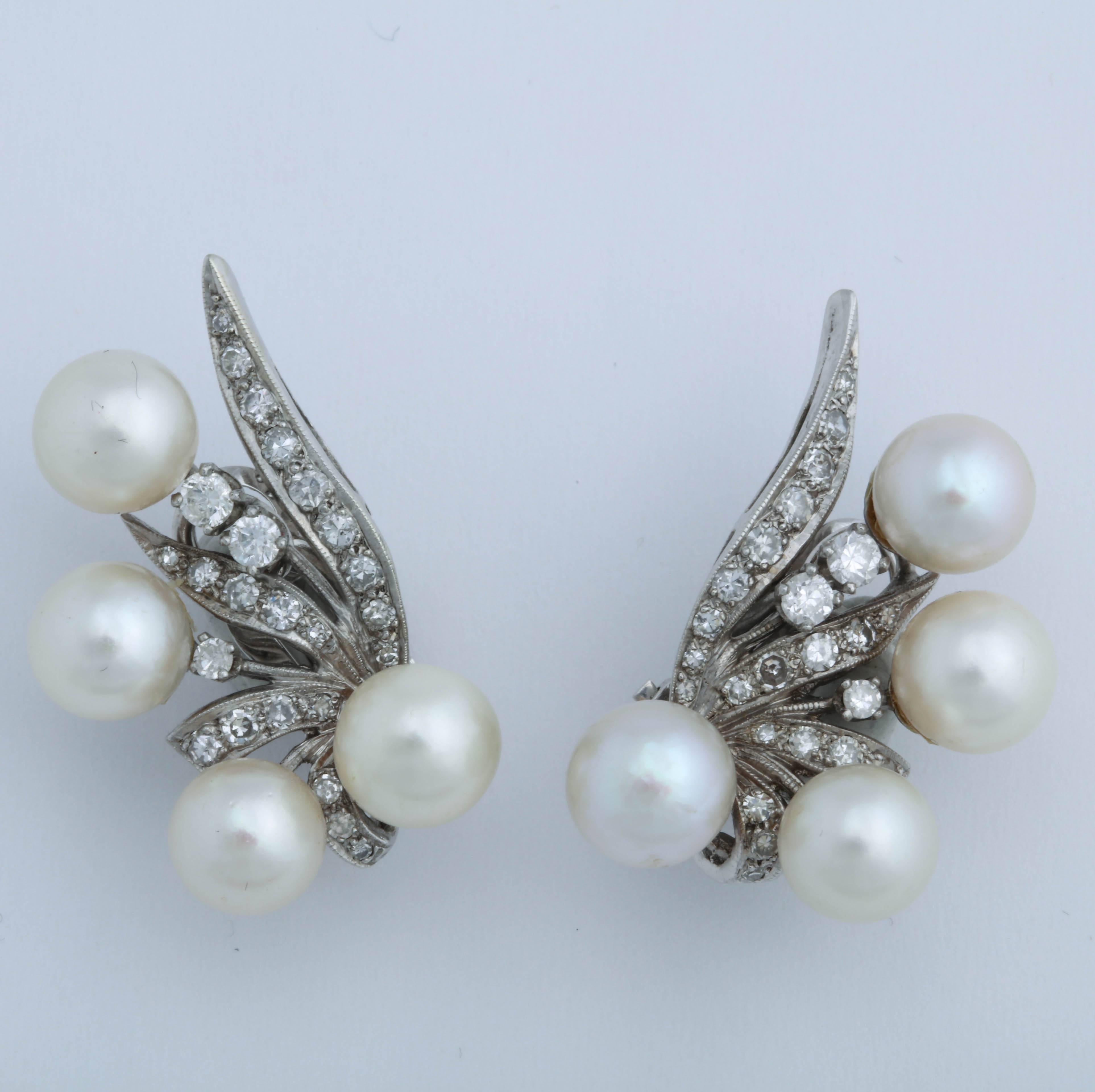 Beautiful cultured Pearls set with single & full cut clean & white Diamonds in a windswept Feather Design.  So 50's and dramatic
