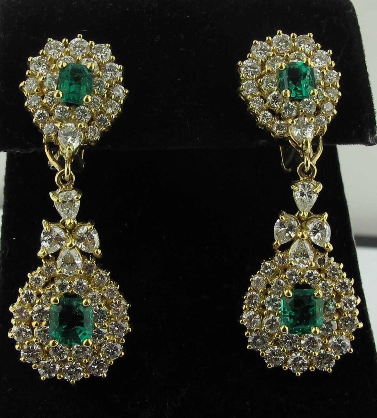 Set in 18 karat yellow gold, these drop earrings are set with 102 round brilliant cut diamonds weighing a total of approximately 5.10 carats, H color, SI clarity and feature four Columbian Emeralds weighing a total of approximately 2.07 carats.   17