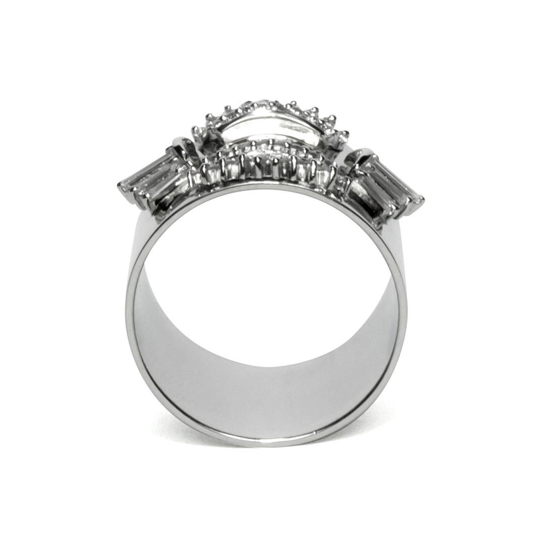 This luxurious wide-band platinum ring features deconstructed elements from repurposed vintage high jewelry stone settings in the center. These rare and classic settings were made by highly skilled craftsmen and include tapered and brilliant cut