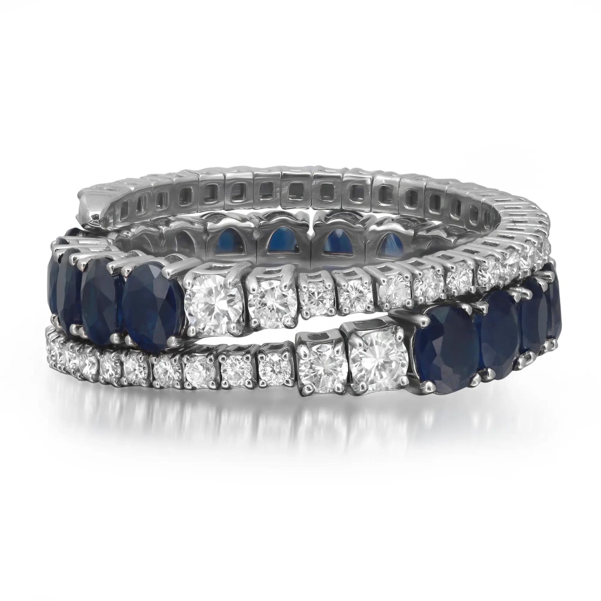 This gorgeous triple row spiral band ring features prong set oval cut blue sapphires in the center with prong set round cut diamonds in a spiral wrap style ring. Crafted in high polished 14K white gold. Total diamond weight: 0.77 carats. Diamond