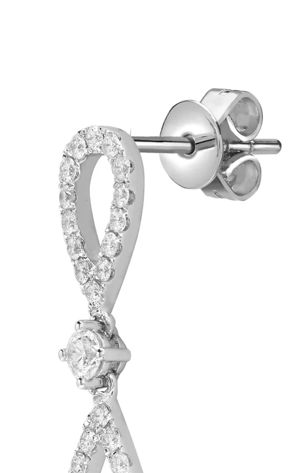 Elegant double pear shape single line connected with a round brilliant cut diamond to create a modern infinity style drops set in 18 karat white gold. Hand finished with an impressive 1 carat diamond total weight, white colour G and SI clarity, each