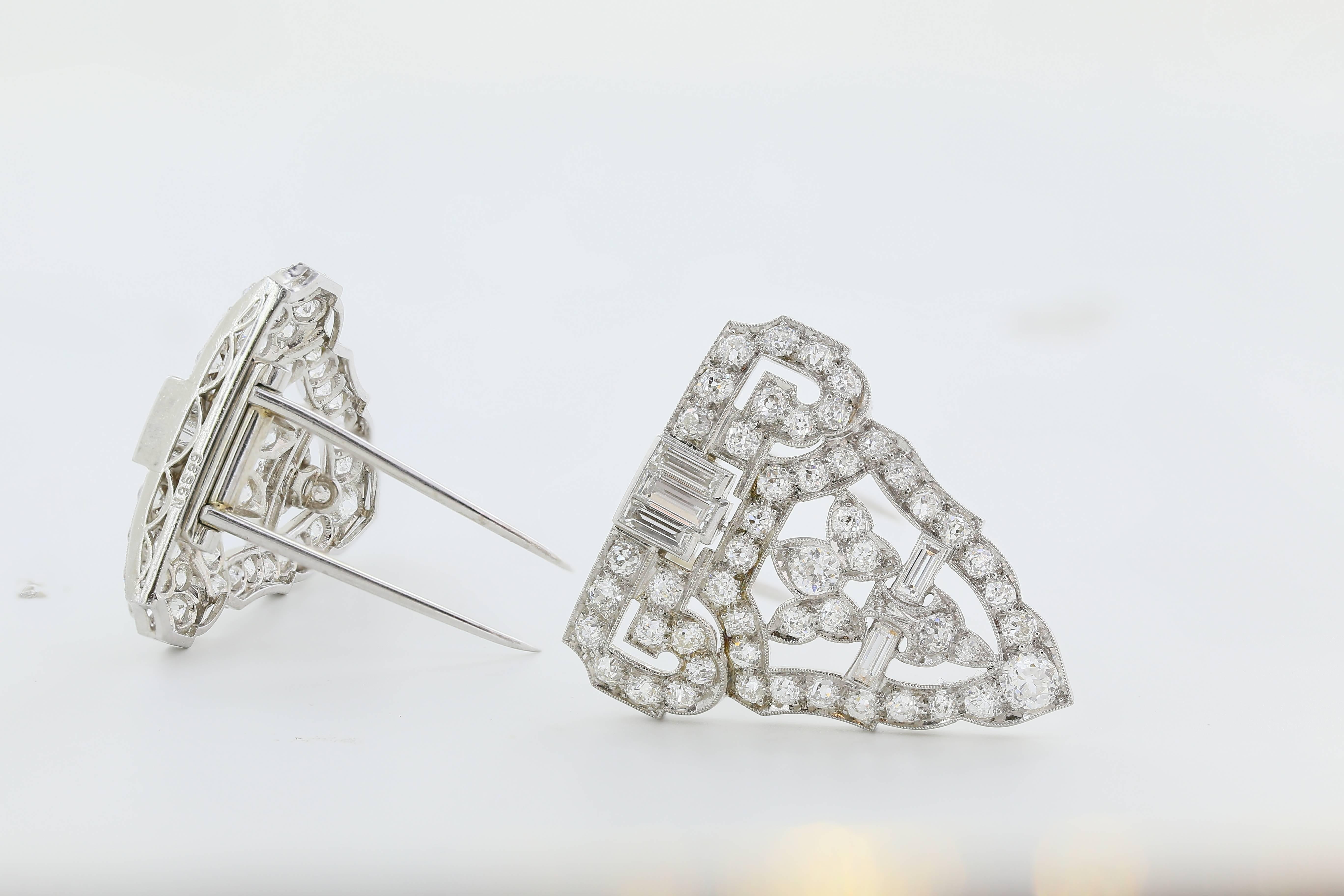 Platinum Art Deco diamond clips/pin consisting of 110 old mine cut and baguette cut diamonds having an approximate total weight of 10.50cts. Circa 1920.