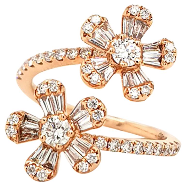 A charming ring designed as two side by side flowers, embellished with the invisibly-set diamonds and mounted in 14k rose gold.
20 baguette diamonds weighing 0.44 carats.
42 round diamonds weighing 0.62 carats.
Total weight of diamonds is 1.06