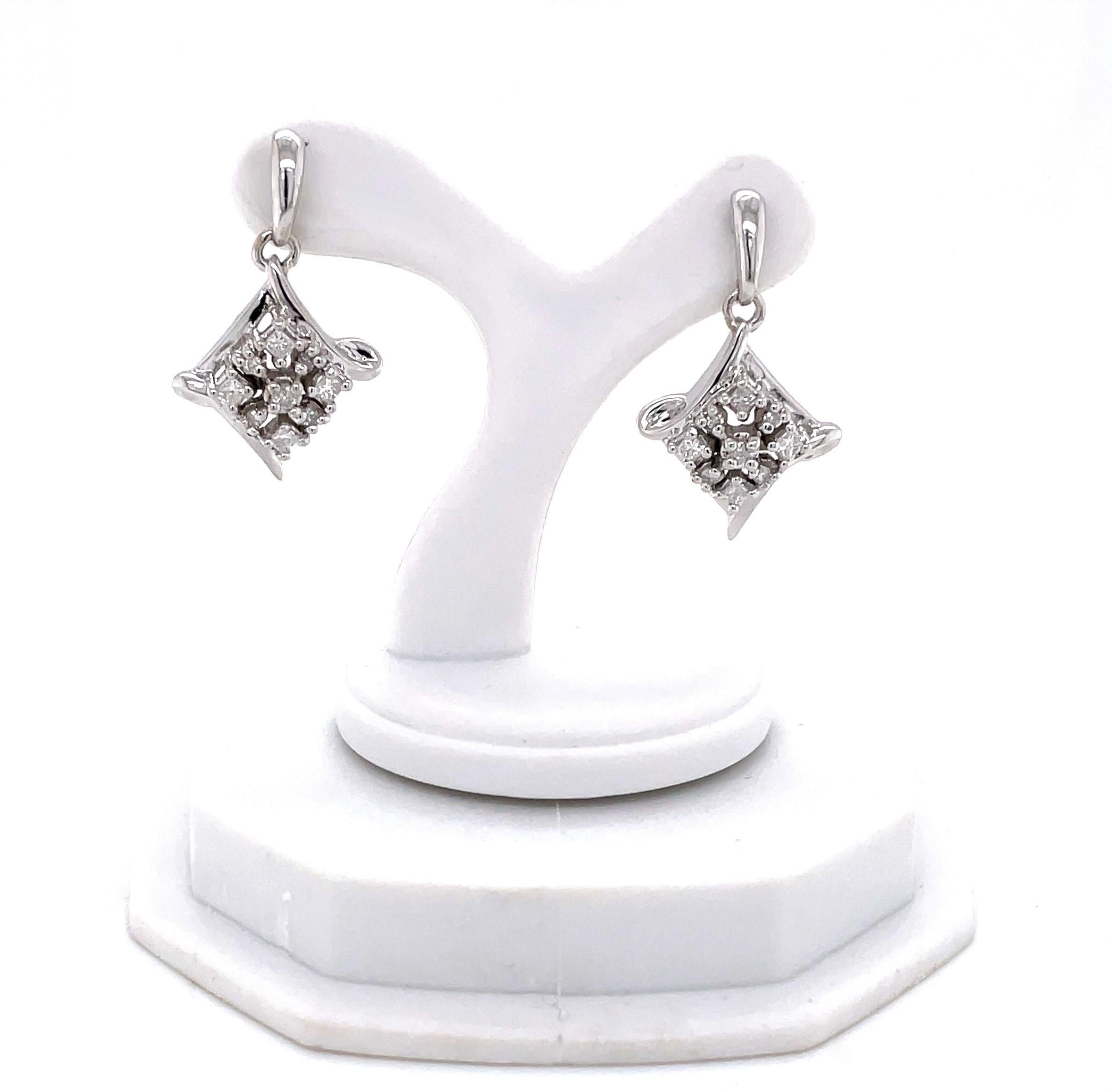 Fab earring pair with plenty of contemporary style and flair sparkling with eighteen diamond accents, .18 carats total weight. For pieced ears, the whimsical marquis shaped fourteen karat 14K white gold drop is approximately 7/8 inch in length. Gift