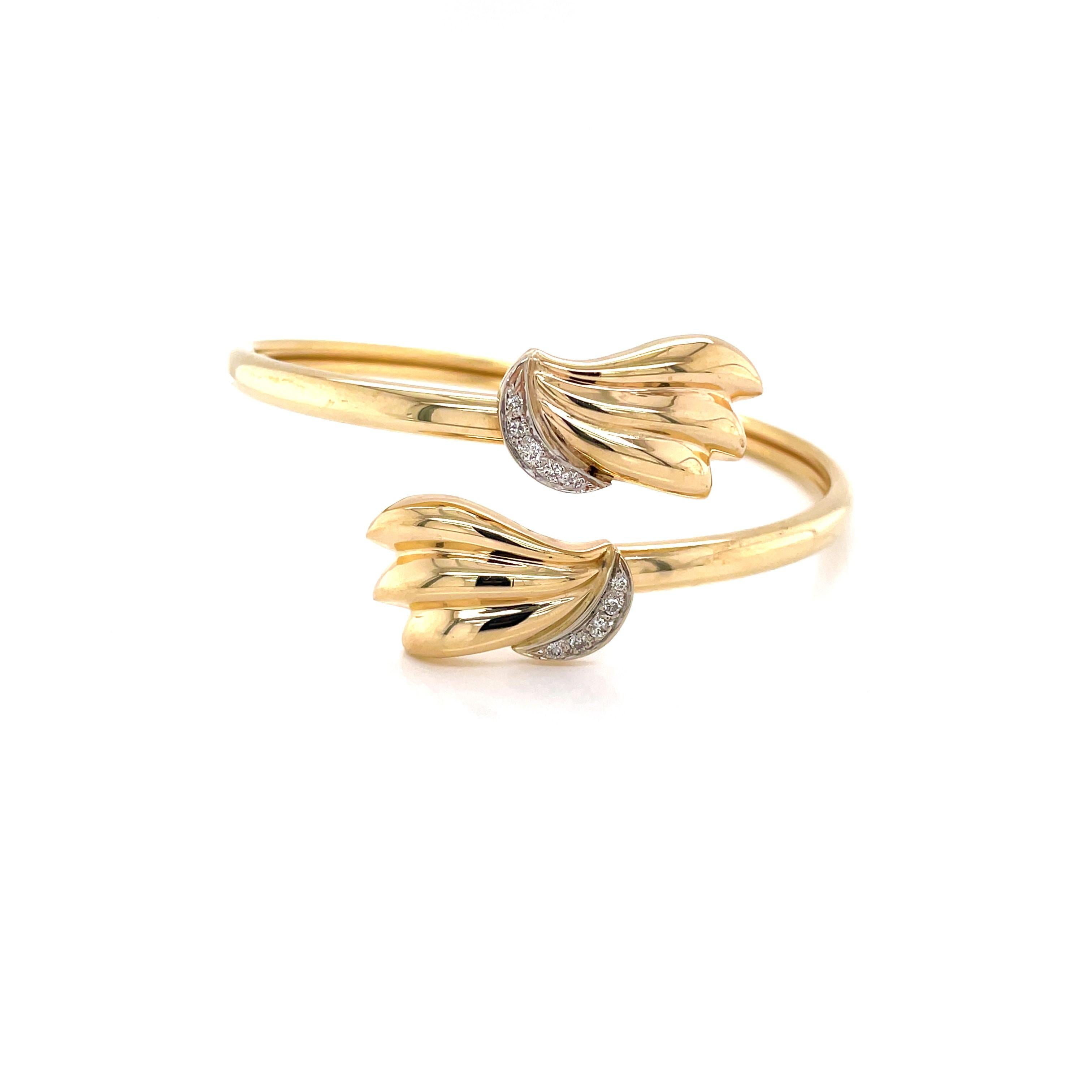Wrap your wrist with a twist of gold and a little extra sparkle. Slender and flexible, measuring 2-3/8 inches in diameter and made of tubular construction, this 14 karat yellow gold bangle is light weight and comfortable to wear.  Flora inspired