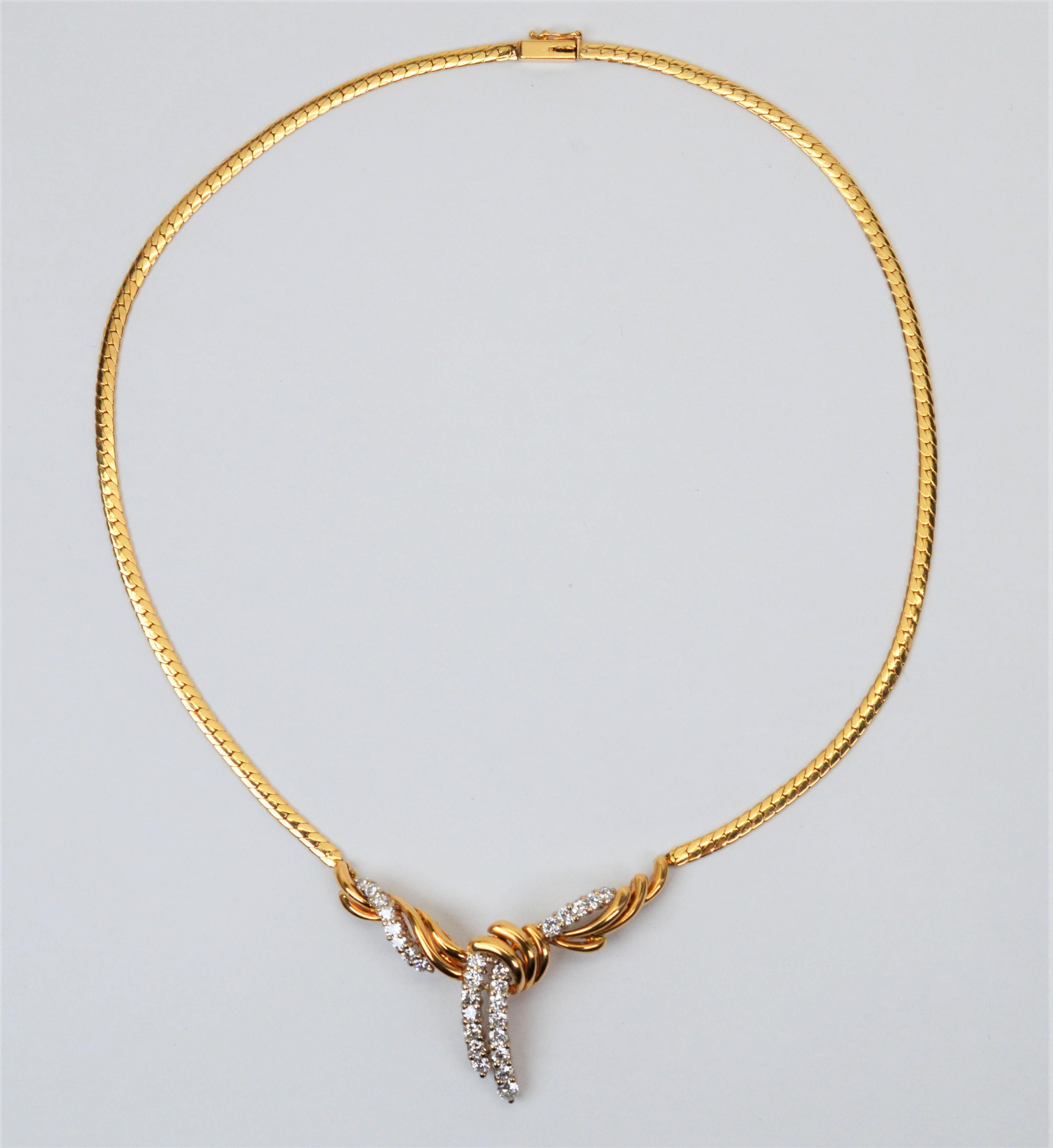 A sumptuous choice for that special occasion. This sophisticated lariat inspired pendant necklace features an integrated sweeping knot of 14K yellow gold adorned with twenty eight .05 faceted round H/VS diamonds, 1.4 carats total weight. The overall