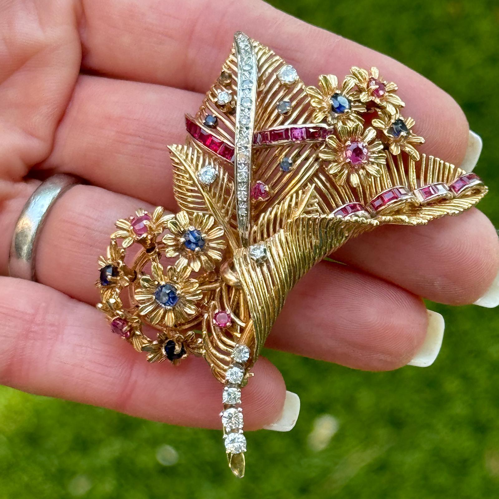 This exquisite tremblant brooch in 14 karat yellwo gold is a display of elegance and movement. What makes this brooch unique is its tremblant feature, where the gemstone flowers tremble or sway with movement, creating an eye catching effect. The