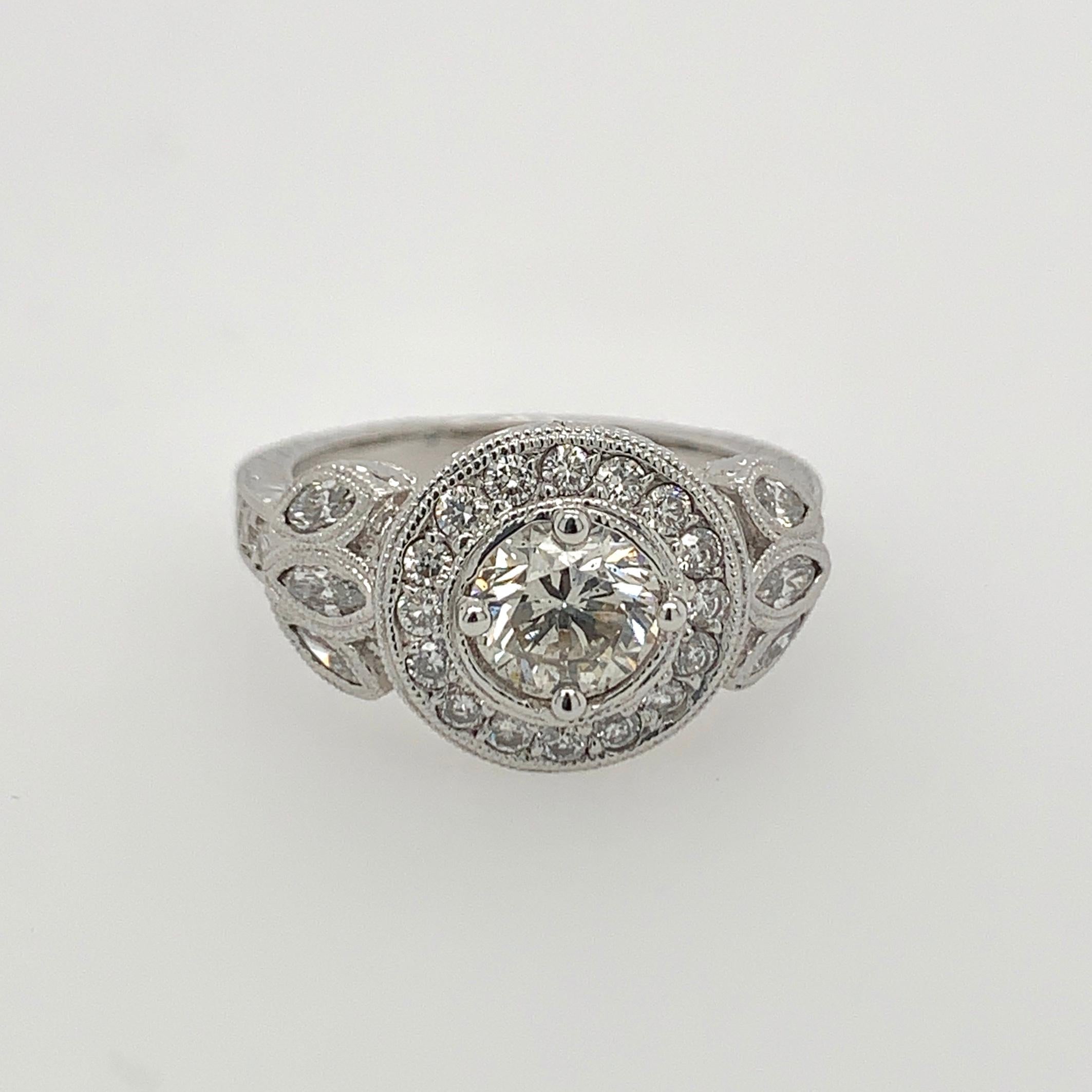 14K white gold contemporary diamond ring with 1.04ct brilliant cut center diamond SI2 clarity, K color, and very brilliant! It is complimented by 22 brilliant cut and 6 marquise cut diamonds. Total weight of this beautiful ring is approximately