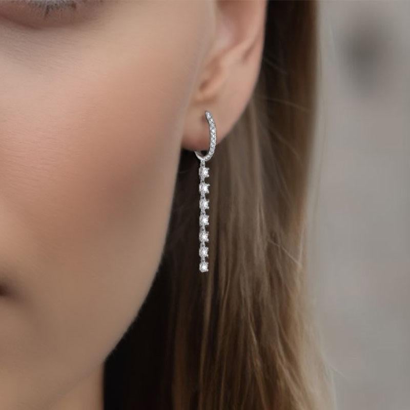 Shine with elegance in these Diamond 14K White Gold Huggie Chain Drop Earrings. Featuring 0.86ct of full-cut diamonds set in a sleek 2.22g design, these earrings offer a captivating sparkle that elevates any look. Perfect for adding a touch of
