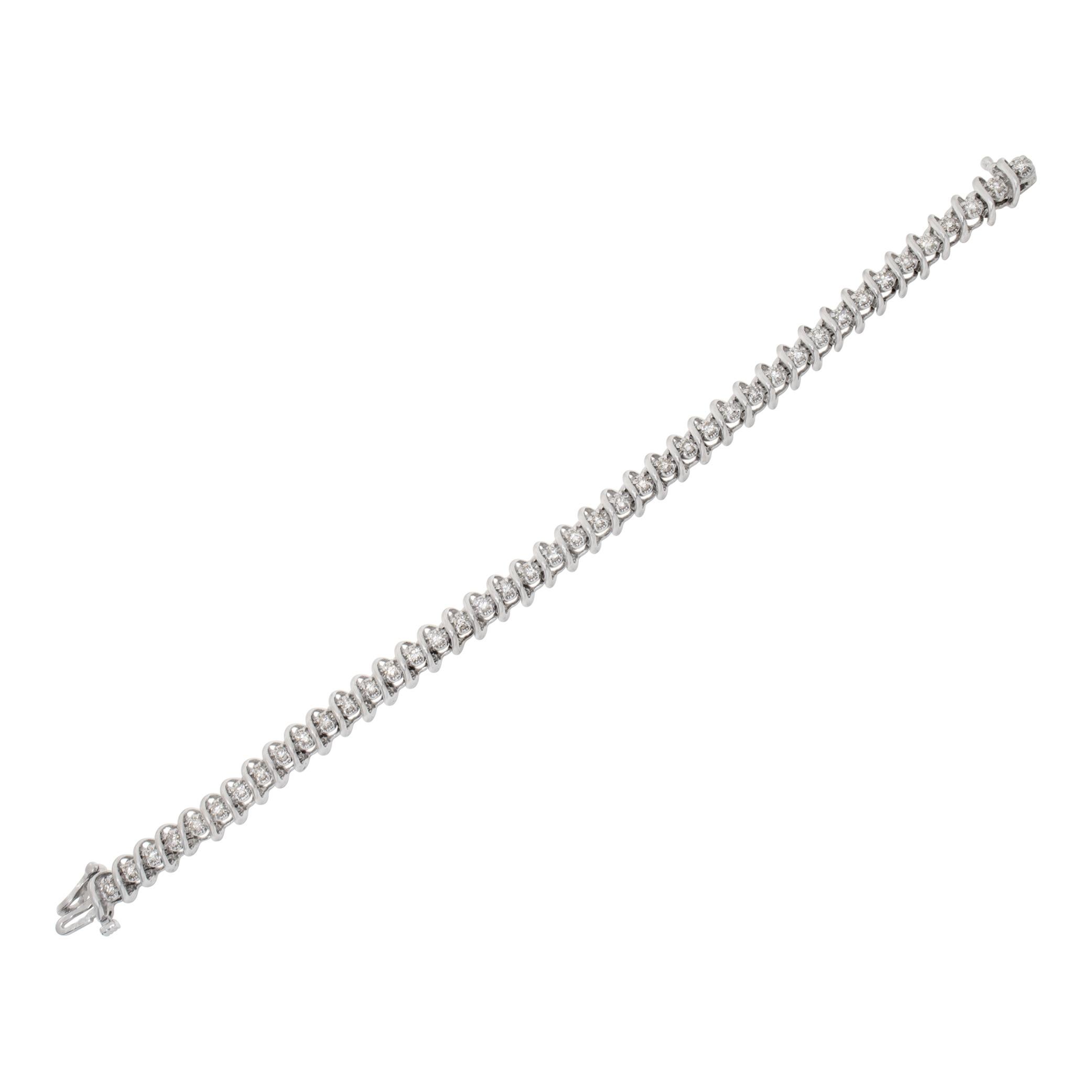 Diamond line bracelet in 14k white gold with approximately 2 carats in round diamonds H-I Color, SI2 Clarity. Length 7.25 inches.