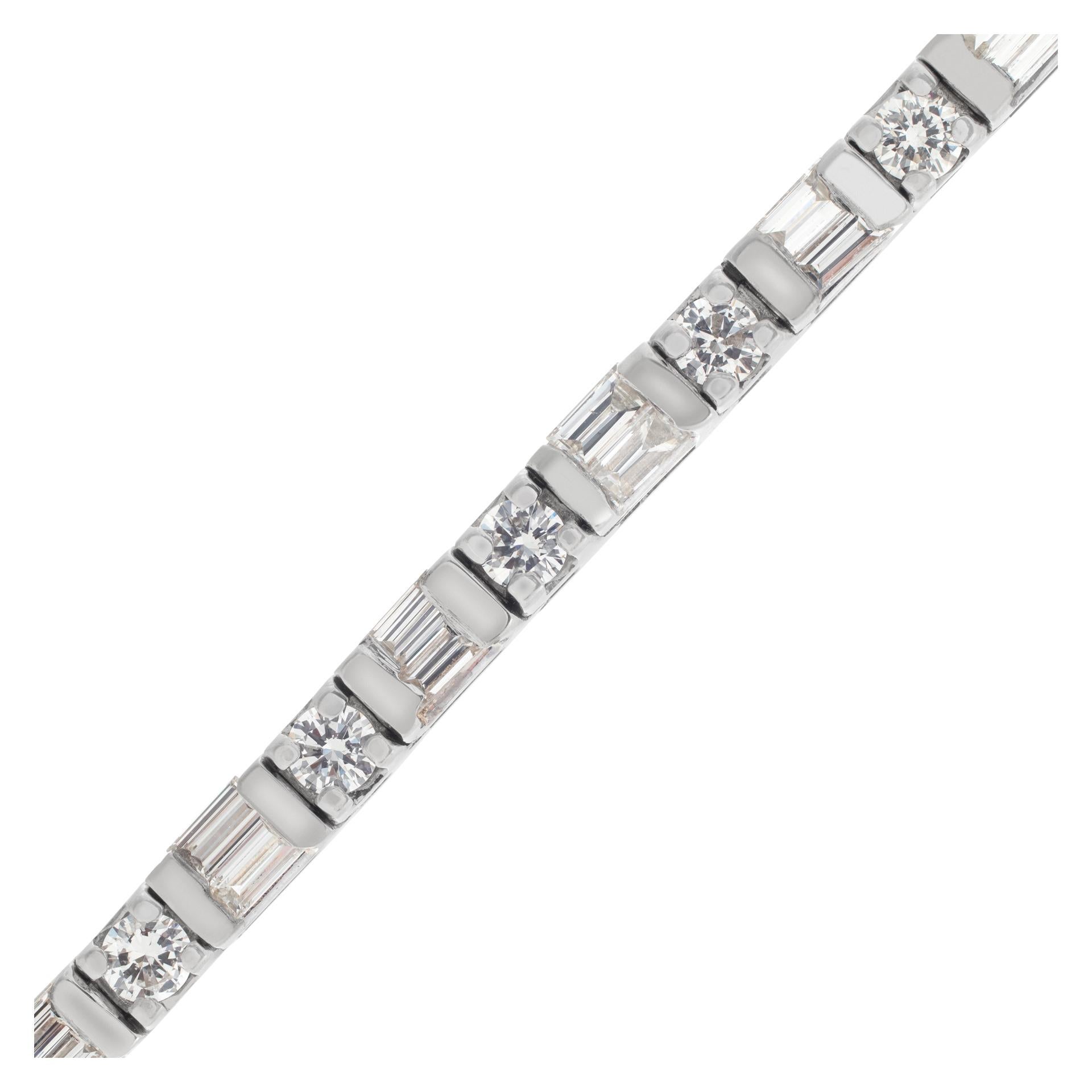 Diamond line bracelet in 14k white gold with over 2 carats in round and baguette cut G-H color, VS-SI clarity  diamonds. Fit for 7 inch wrist, measures 3mm thick.

